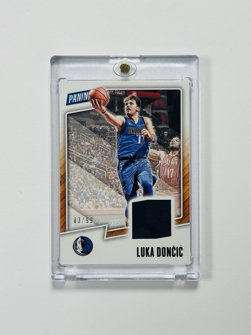 2018-19 PANINI FATHERS DAY LUKA DONCIC #LD ROOKIE PLAYER WORN PATCH/ 99: 2018-19 PANINI FATHERS DAY LUKA DONCIC #LD ROOKIE PLAYER WORN PATCH/ 99 Luka Doncic's rookie card from the 2018-19 Panini Fathers Day set, featuring a rare player-worn patch, graded to an impressive 9
