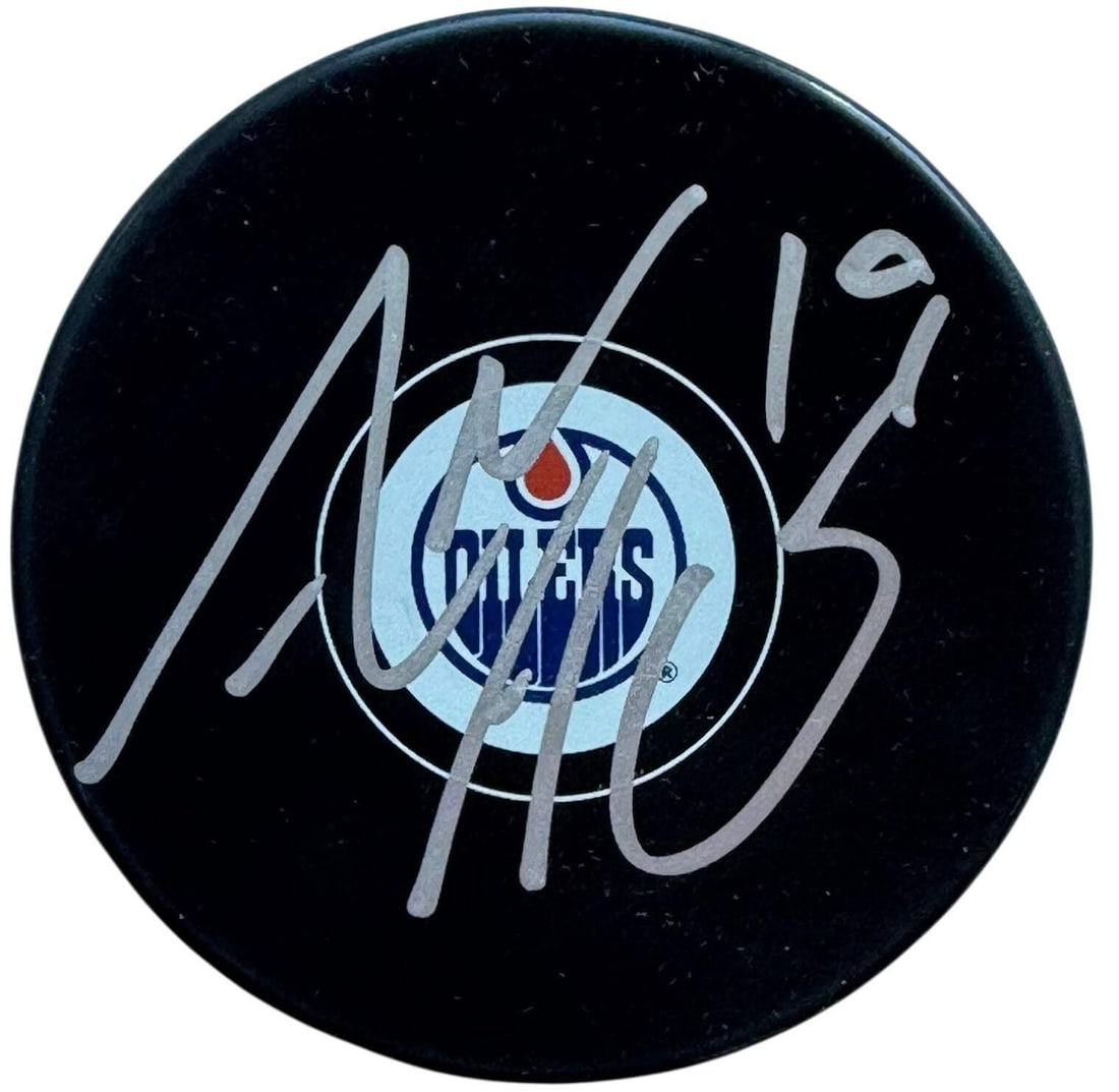Adam Henrique Autographed Edmonton Oilers Logo Puck (Beckett): Adam Henrique Autographed Edmonton Oilers Logo Puck (Beckett) Adam Henrique's silver sharpie signature adds a touch of authenticity to this Edmonton Oilers logo puck, bearing the mark of Beckett