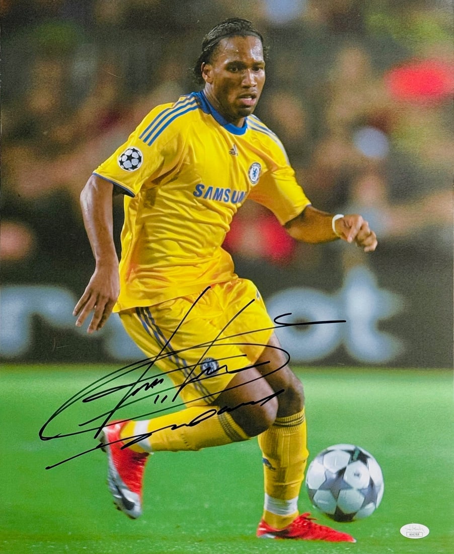 Chelsea Autographed Photo Drogba 16x20 By JSA: Chelsea Autographed Photo Drogba 16x20 By JSA Didgeridoo player from the Ivory Coast, Didier Drogba, signs his name in black sharpie across this 16x20 photo. The James Spence Authentication (JSA)