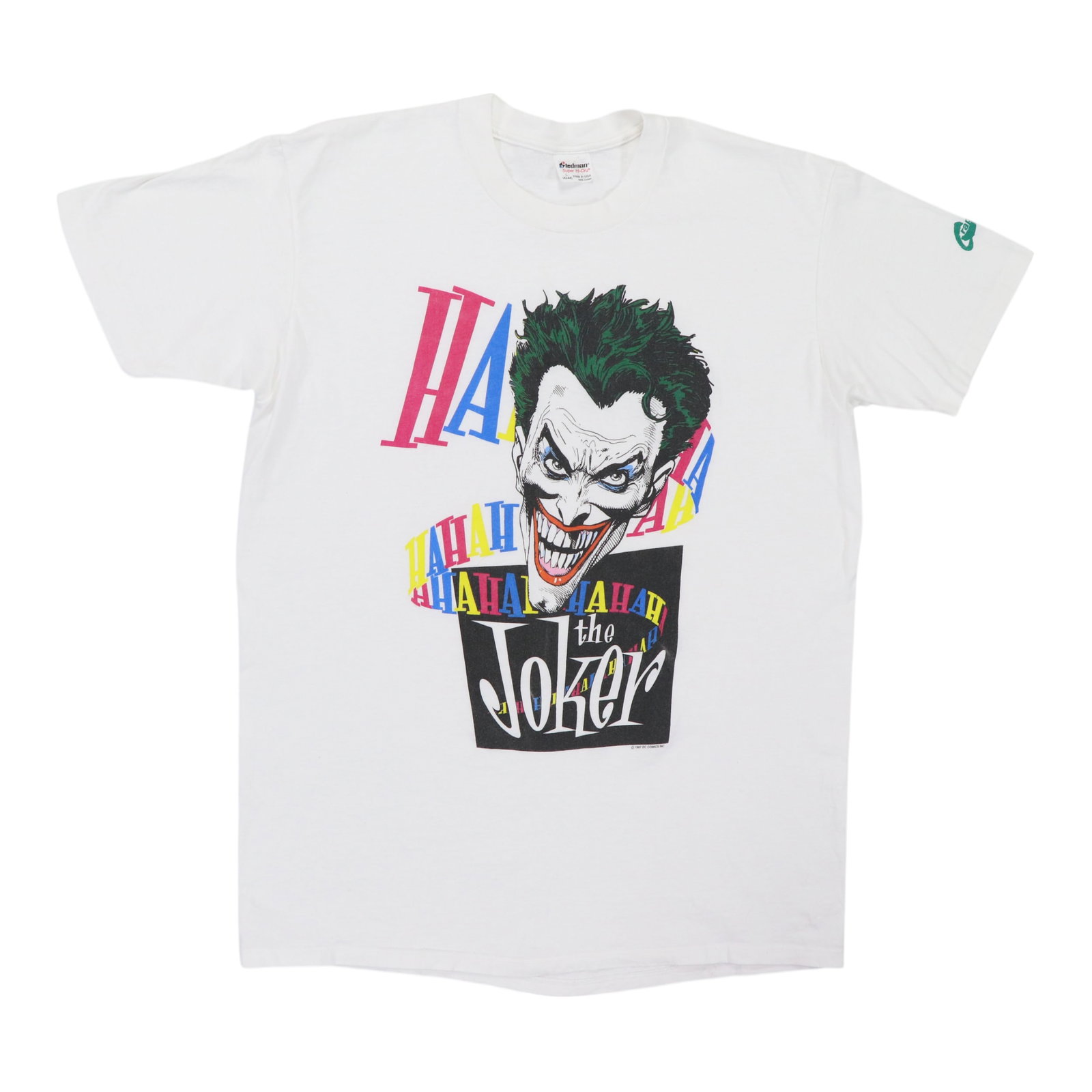 Joker HaHaHa Shirt DC Comics Graphitti 1987: Joker HaHaHa Shirt DC Comics Graphitti 1987 The Joker HaHaHa DC Comics Graphitti Shirt from 1987 is a true vintage find, boasting a bold white design with no back graphics. Made from 100% cotton, the 