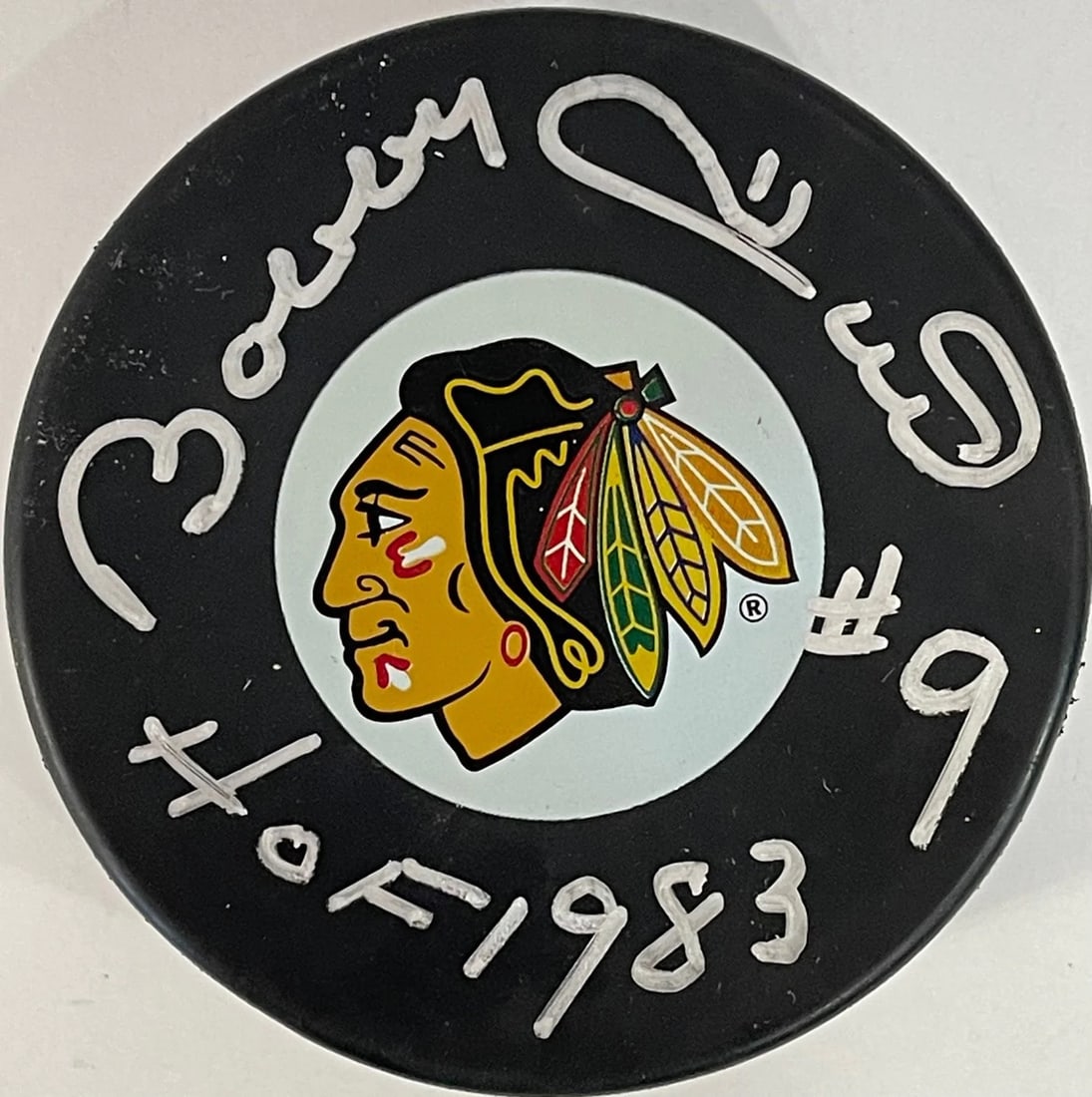 Chicago Blackhawks Bobby Hull Autographed Puck: Chicago Blackhawks Bobby Hull Autographed Puck Bobby Hull's iconic silver sharpie signature adorns the front of this official Chicago Blackhawks puck, bearing the inscription "HOF 83". The puck
