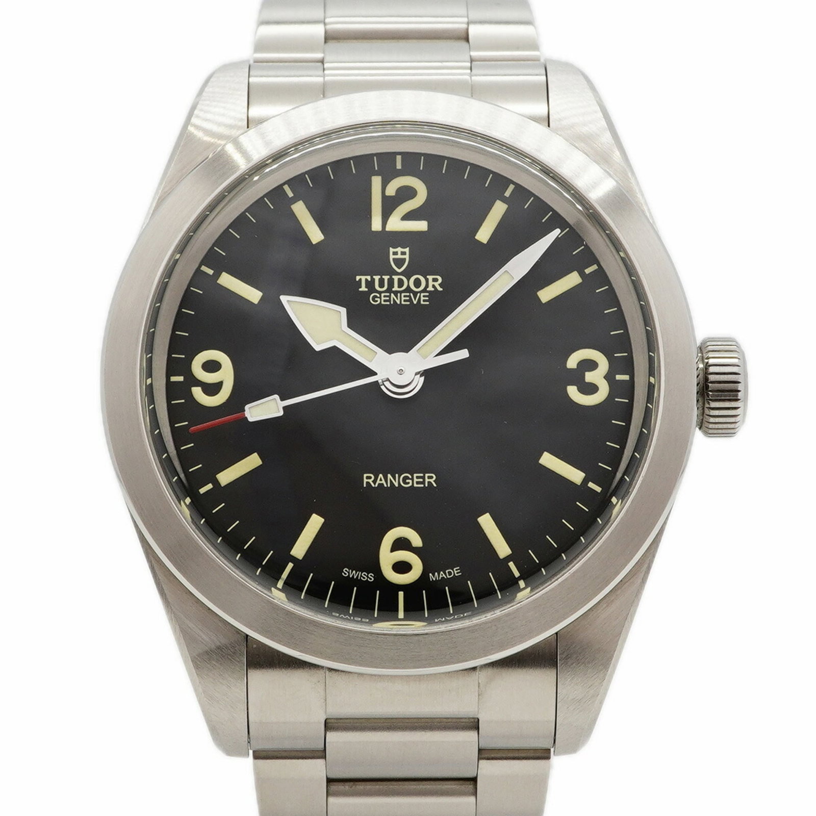 Tudor Wristwatch: Tudor Wristwatch Stainless steel band adds a touch of durability to this black dial Tudor wristwatch, featuring a 39mm case diameter. The watch has been well-cared for, with some minor scratches and d
