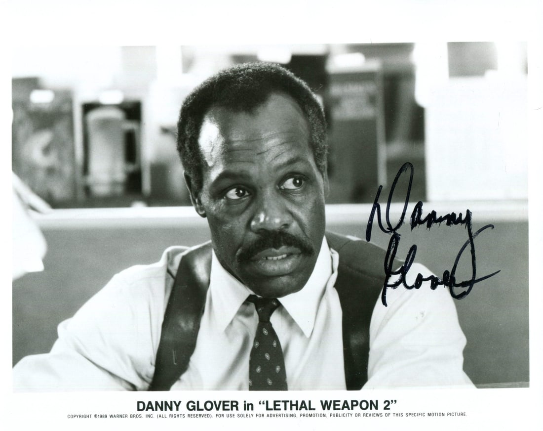 Autographed Photo By Danny Glover: Autographed Photo By Danny Glover Danny Glover's bold signature in black sharpie adds a touch of authenticity to this rare 8x10 photo, bearing the unmistakable mark of one of Hollywood's most iconic s