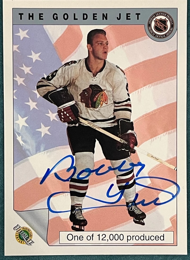 Bobby Hull Autographed Trading Card Ultimate Company Card: Bobby Hull Autographed Trading Card Ultimate Company Card Bobby Hull's iconic autograph adorns the front of this Ultimate Trading Card Company card, signed across the surface in blue sharpie. The