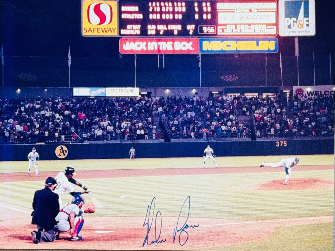 Nolan Ryan Autographed Baseball Photo: Nolan Ryan Autographed Baseball Photo Signed by Juan Lagares in silver sharpie, this 11x14 baseball photo showcases the artist's mark across its front. The item bears a signature that can be verified