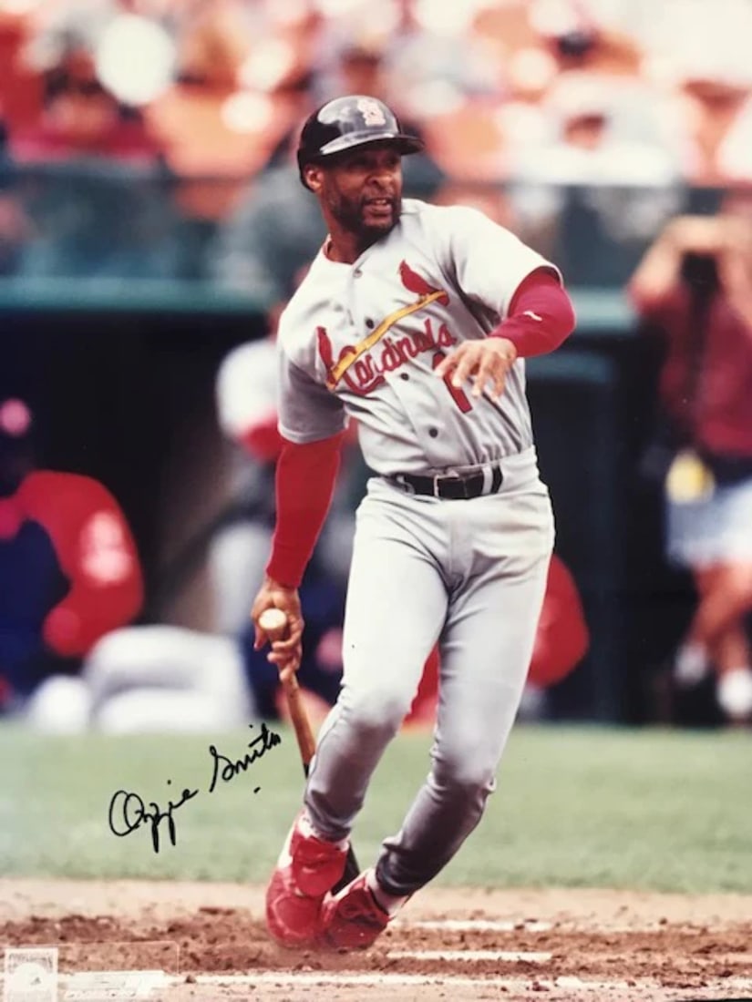 Smith Ozzie Autographed Baseball 8x10 Photo: Smith Ozzie Autographed Baseball 8x10 Photo Ozzie Smith's iconic baseball career is captured in this 8x10 photo, signed across the front in blue sharpie. The legendary shortstop's signature is a