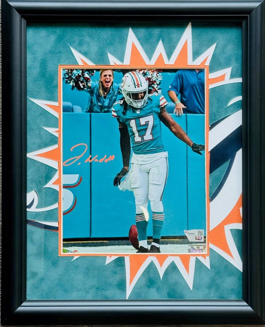 Jaylen Waddle Fanatics Autographed Framed Photo 8x10: Jaylen Waddle Fanatics Autographed Framed Photo 8x10 Jaylen Waddle's vibrant personality shines through in this 8x10 framed photo, signed in bold orange sharpie across the front. The Beckett Professio