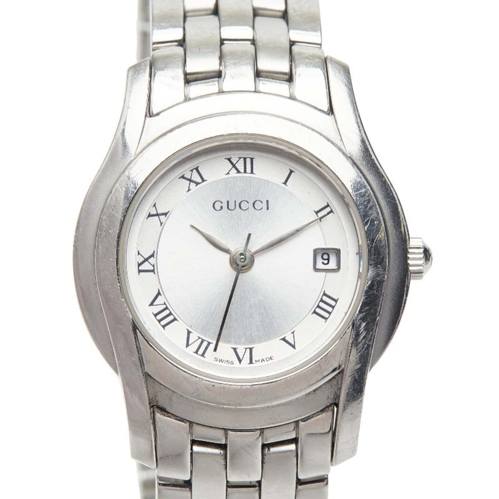 Gucci Wristwatch: Gucci Wristwatch Stainless steel case and band provide a sleek, modern look. The silver dial stands out against the neutral background, adding a touch of sophistication to this quartz-powered