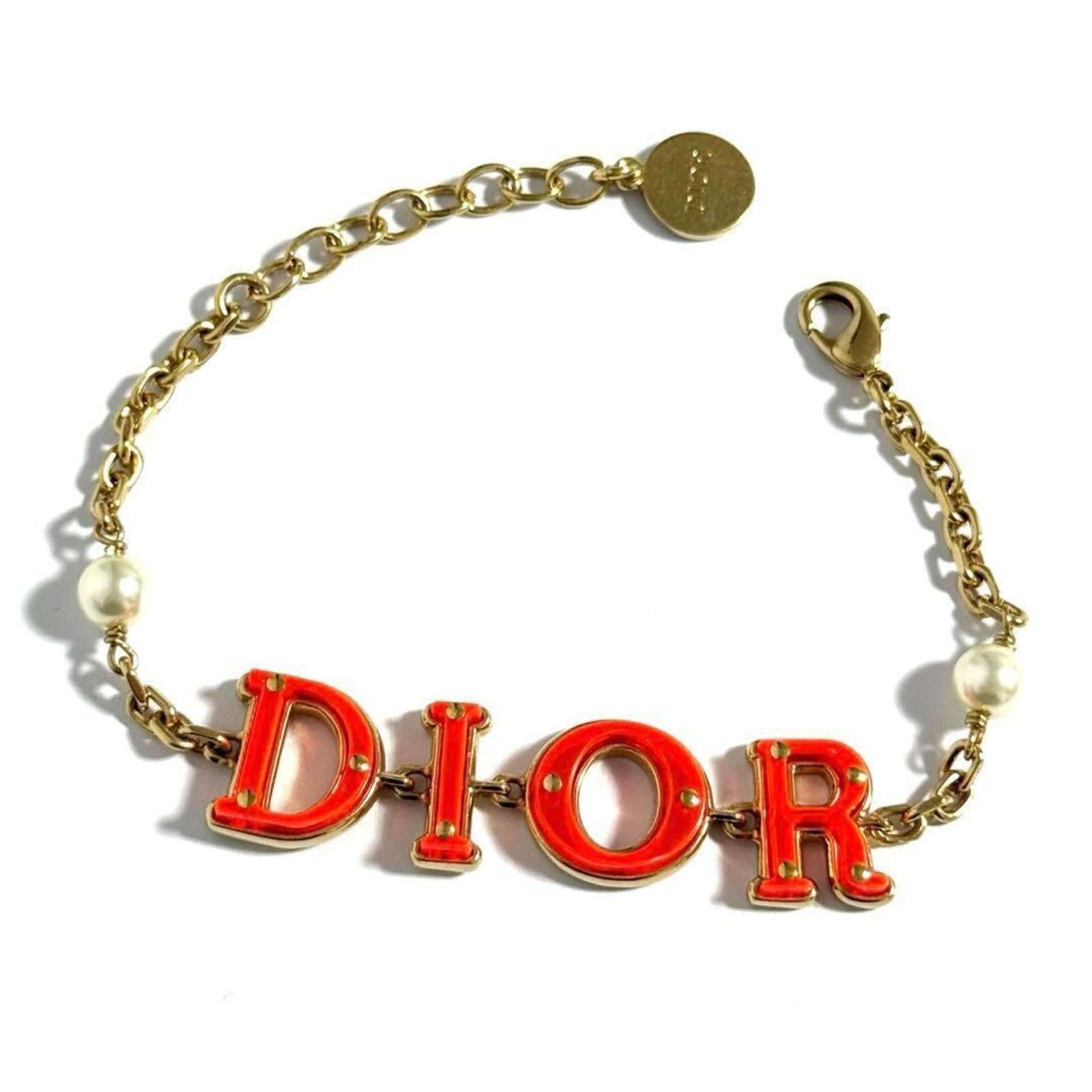 Christian Dior Charm Metal Pearl Artificial: Christian Dior Charm Metal Pearl Artificial Christian Dior Charm Metal Pearl Artificial bracelet boasts an elegant design featuring artificial pearl accents, crafted from high-quality metal. This