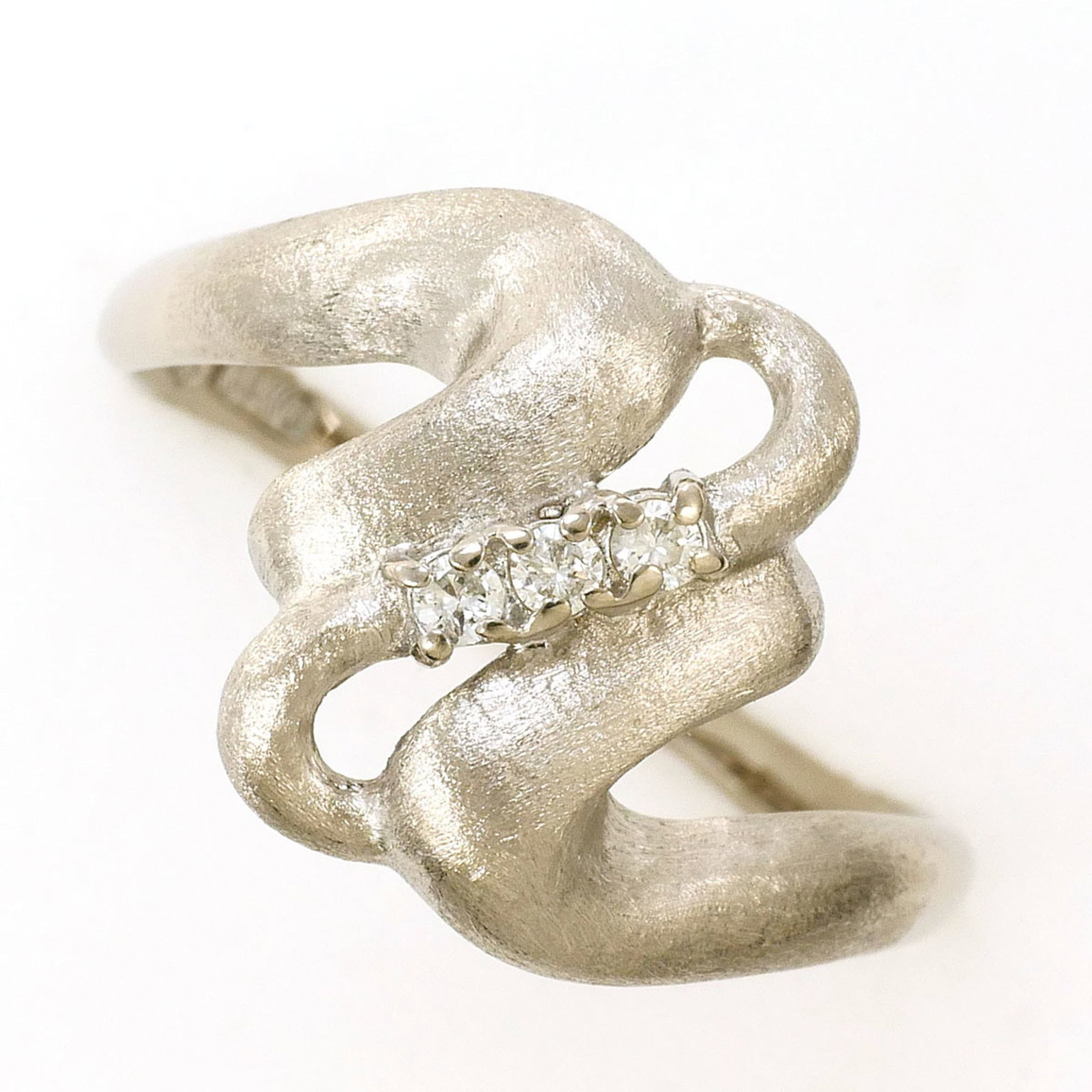 Unbranded Band Ring White Gold (14K): Unbranded Band Ring White Gold (14K) This unbranded white gold band ring features a 0.04 carat diamond and measures 12mm in width, making it a simple yet elegant accessory for everyday wear. Crafted