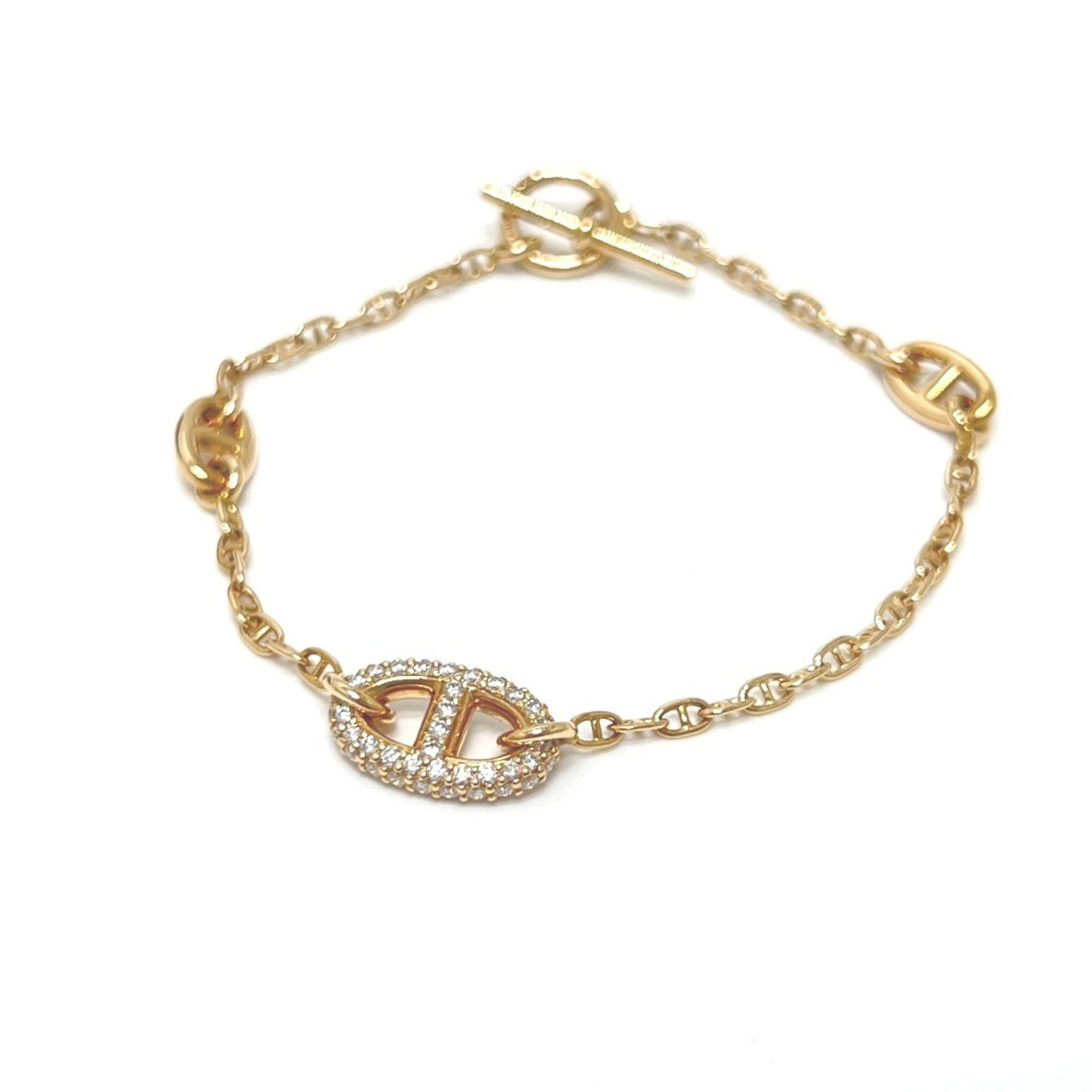 Pink Gold 18K Hermes Charm Bracelet: Pink Gold 18K Hermes Charm Bracelet Pink gold 18K Hermes Charm Bracelet features a delicate pink gold chain with a diamond stone, measuring 15.5cm in length and presented in a box and case. This elega