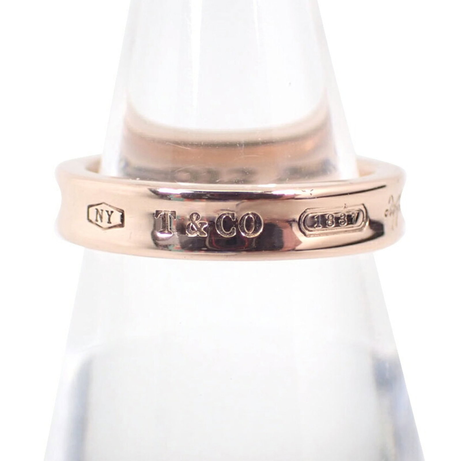 Ring Tiffany Band Metal: Ring Tiffany Band Metal Tiffany Type band ring in gold metal, available in US size 5 and JP size 9. This classic design features a simple yet elegant metal band that can be worn on its own or paired