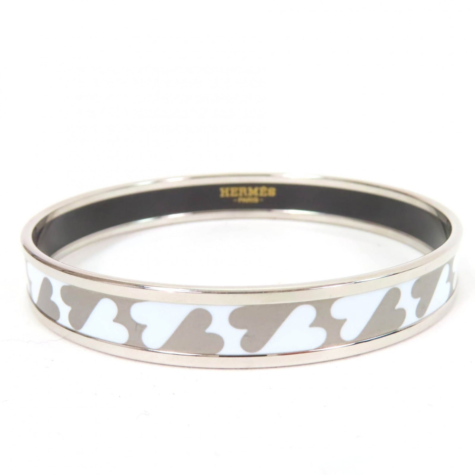 Hermes Charm bracelet enamel: Hermes Charm bracelet enamel Silver and white enamel details adorn the Hermes charm bracelet, adding a touch of elegance to its slender 20cm length. This beautifully crafted piece comes with a