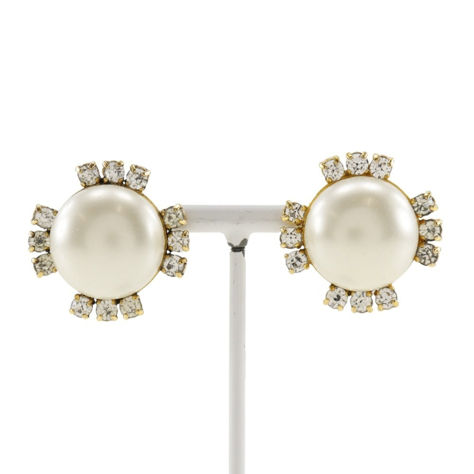 Clip earrings by Chanel: Clip earrings by Chanel Clip earrings by Chanel, crafted in gold with a rhinestone stone, measuring 30.00mm x 30.00mm and weighing 25.6g. These elegant clip earrings showcase the iconic style of
