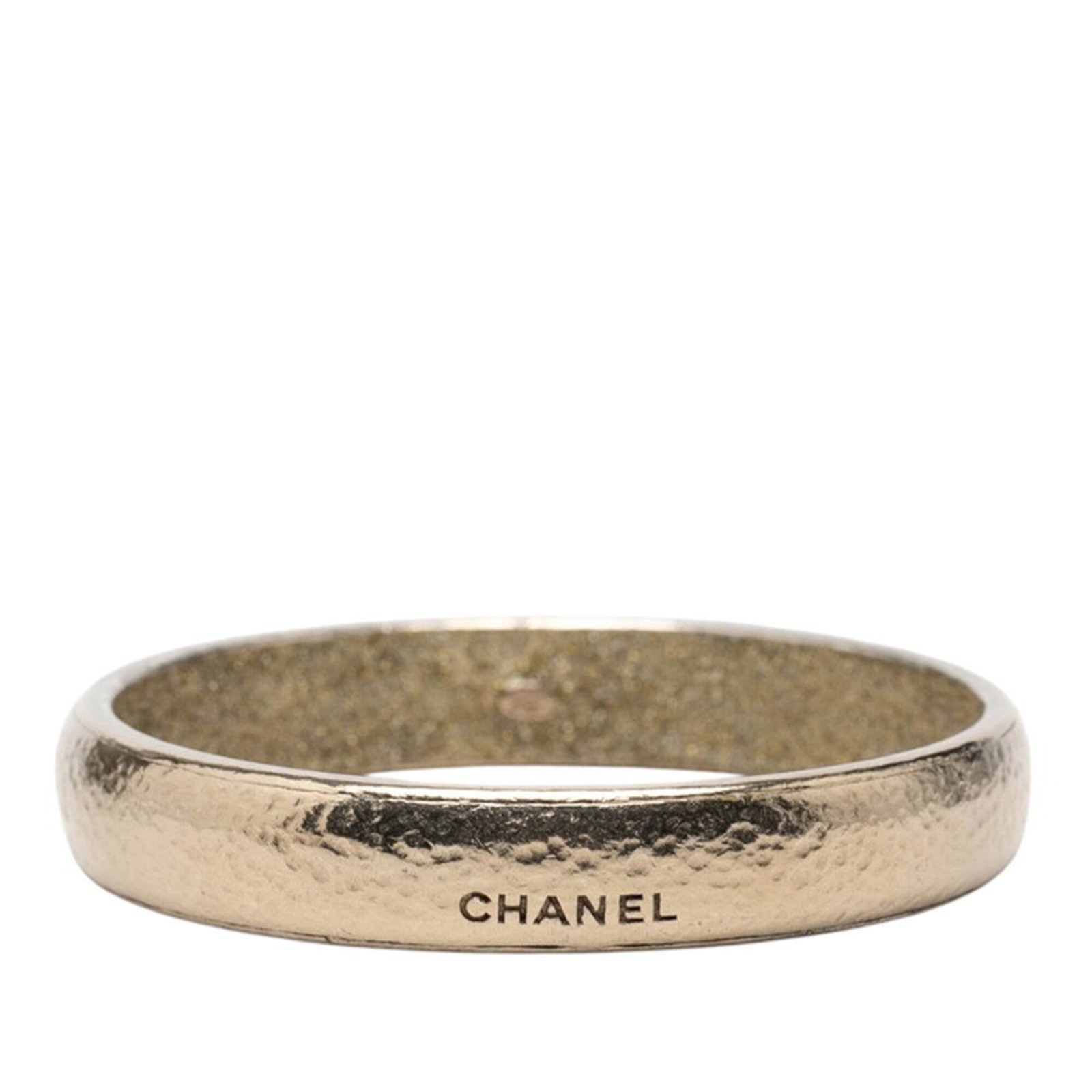 Chanel Bangle: Chanel Bangle Champagne gold bangle from Chanel, measuring 19.5cm in length. This elegant piece boasts the iconic brand's signature style and craftsmanship. With its understated sophistication, it