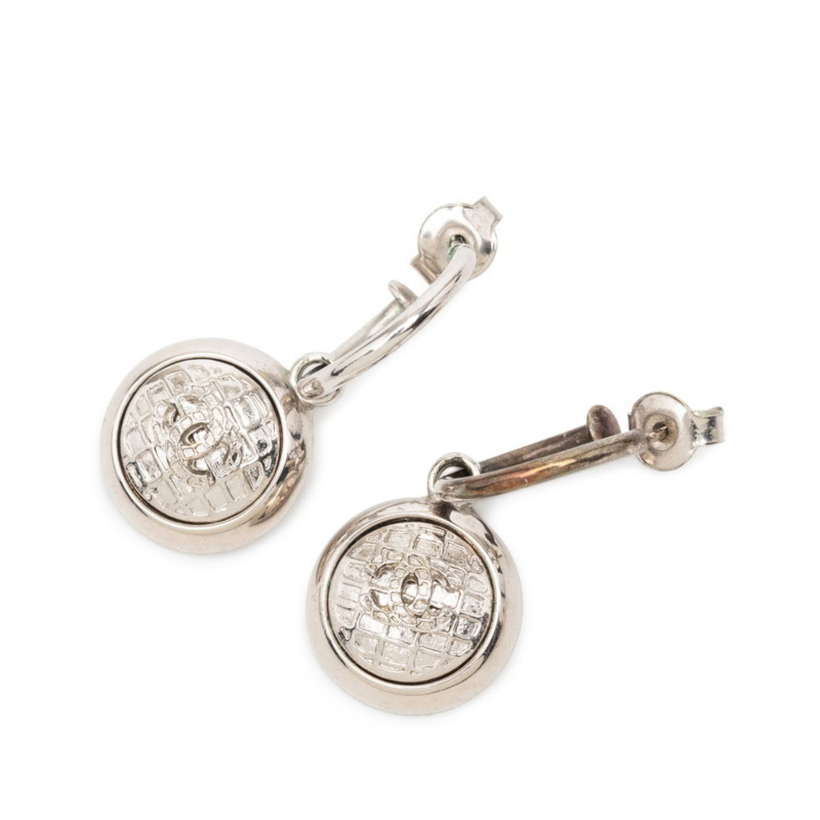 Metal Stud Chanel Earrings: Metal Stud Chanel Earrings Metal Stud Chanel Earrings in Silver, measuring 13.20mm x 13.60mm x 11.00mm, bearing a signature from the renowned fashion house. These stud earrings showcase a sleek and