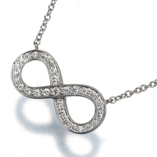 Diamond infinity necklace 950 platinum Tiffany Co.: Diamond infinity necklace 950 platinum Tiffany Co. 950 platinum Tiffany Co. diamond infinity necklace with a natural diamond pendant, set in a sturdy platinum pendant and chain combination. The neckla