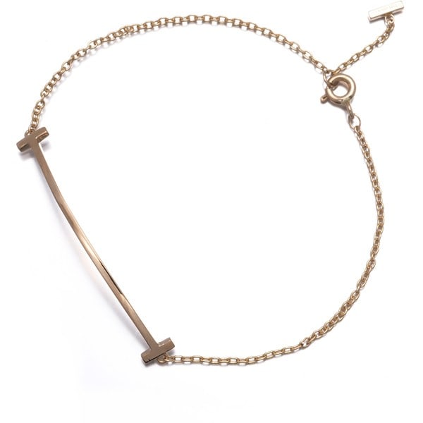 Tiffany Co bracelet with small rose gold 18k 750 smile and Tiffany t: Tiffany Co bracelet with small rose gold 18k 750 smile and Tiffany t Tiffany & Co. rose gold bracelet with small 18k 750 smile and Tiffany T logo, featuring a classic design with subtle elegance. The