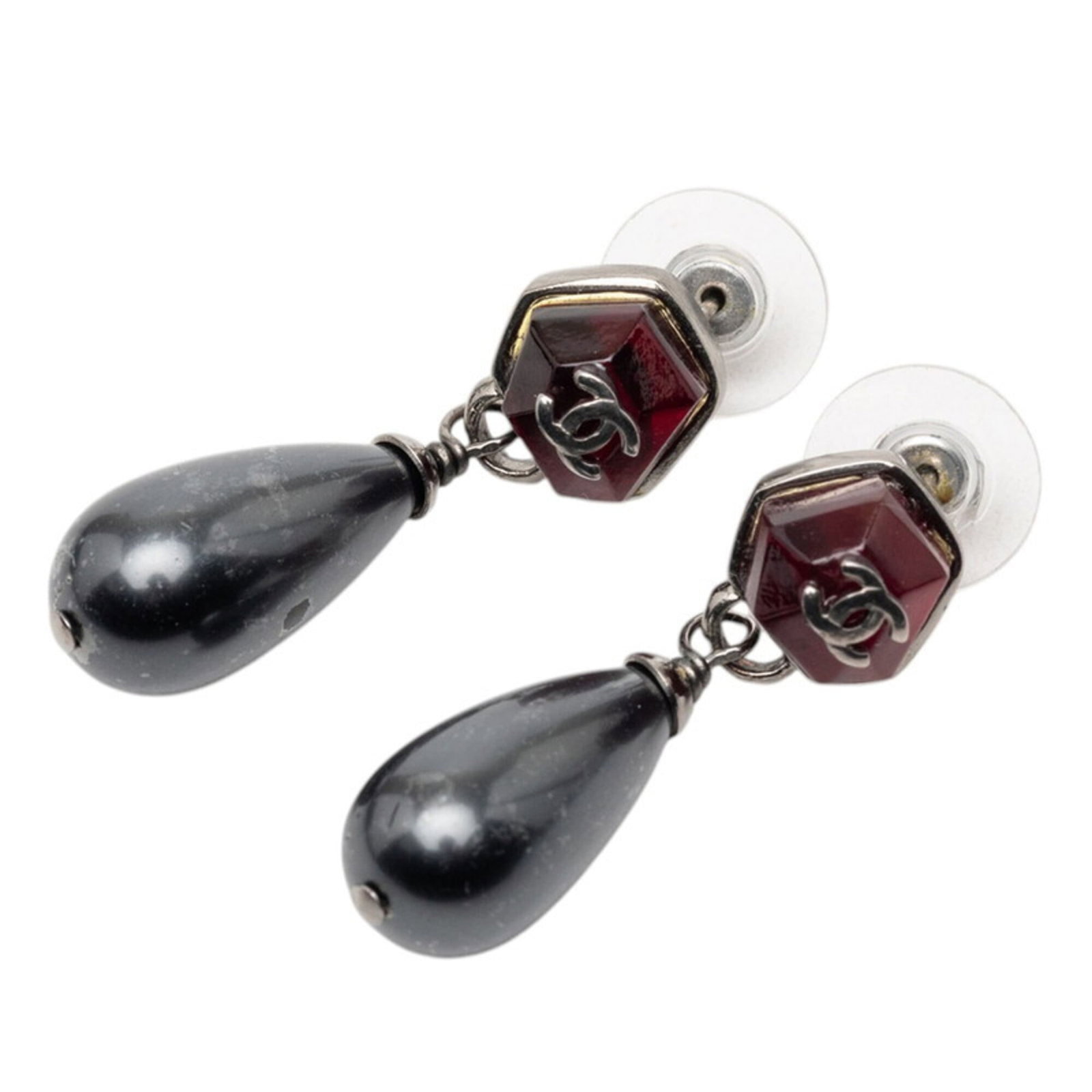 Earrings Drop Metal By Chanel: Earrings Drop Metal By Chanel Drop metal earrings by Chanel feature artificial pearl and rhinestone details in silver. The sleek design measures 37.20mm x 11.40mm, with a black stone accent. Made