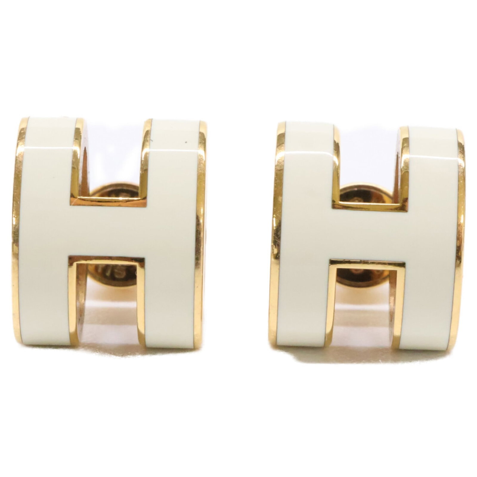 Metal earrings by Hermes Stud: Metal earrings by Hermes Stud Metal earrings by Hermes Stud are crafted from high-quality metal, featuring a sleek and modern design. The gold and white stud earrings measure 12mm x 10mm in size,