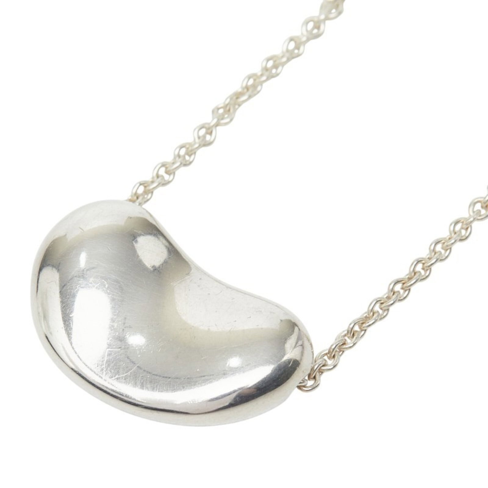Tiffany & Co. Bean Necklace Sv925 Silver Women'S.: Tiffany & Co. Bean Necklace Sv925 Silver Women'S. Tiffany & Co.'s Bean Necklace is a striking silver piece, crafted from high-quality 925 Silver. The necklace boasts a sleek design with a pendant meas