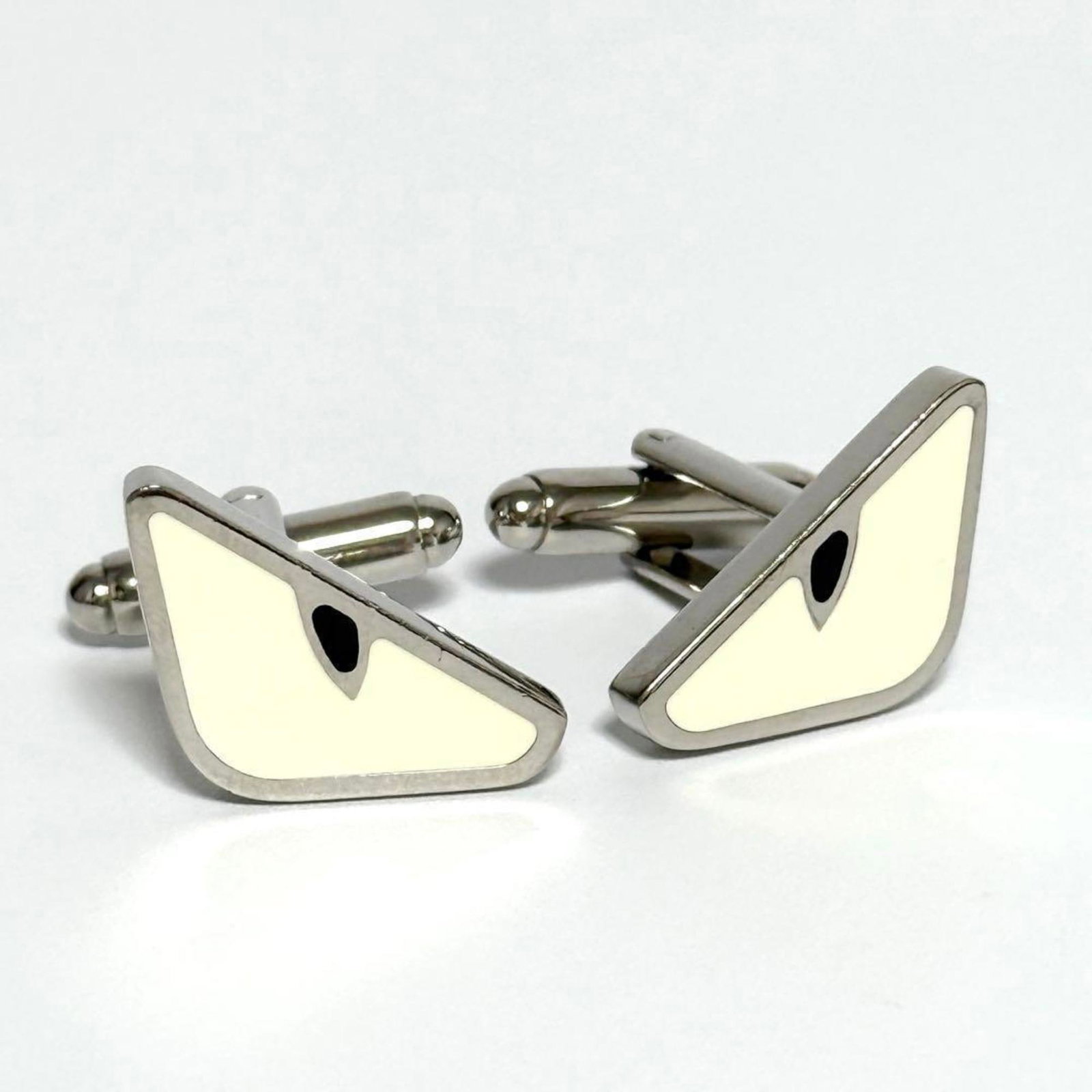 Cufflinks metal by Fendi: Cufflinks metal by Fendi Cufflinks by Fendi, crafted from metal with a size of 15.00mm x 18.00mm. The item bears no additional accessories and features the brand's name as its only identifier. Metal