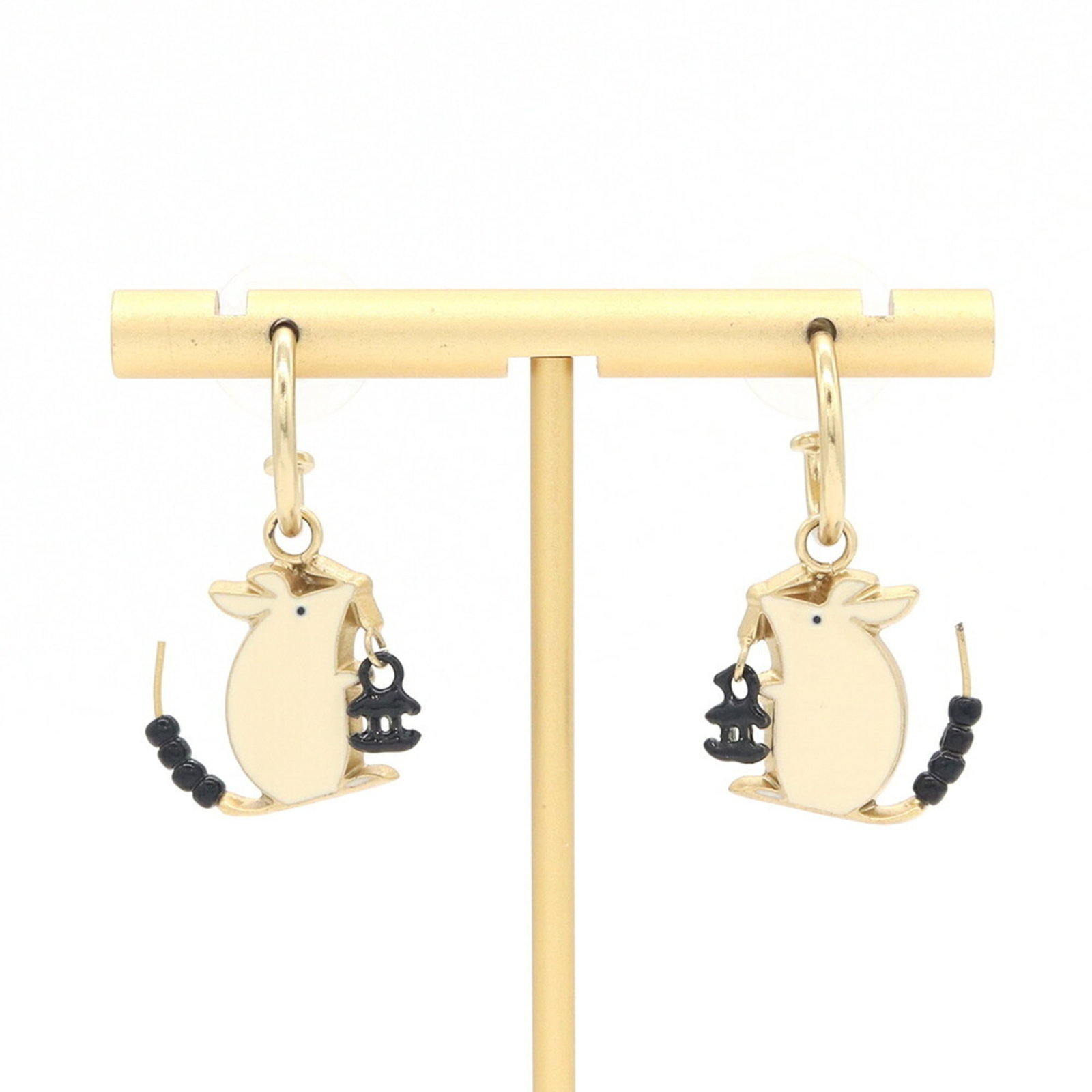 Metal hoop earrings by Chanel: Metal hoop earrings by Chanel Metal hoop earrings by Chanel, crafted from high-quality metal with a sleek black and cream finish. Measuring 20mm x 18mm in diameter, these elegant hoops are adorned