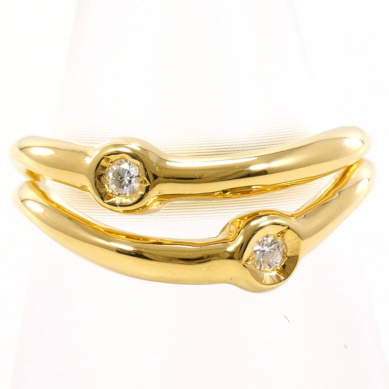 Unbranded Band Ring Yellow Gold (18K): Unbranded Band Ring Yellow Gold (18K) Yellow gold band ring with a diamond stone, crafted from 18K metal. Weighing just 4g, this delicate piece is available in US size 5.5 and JP size 10.5. Made from