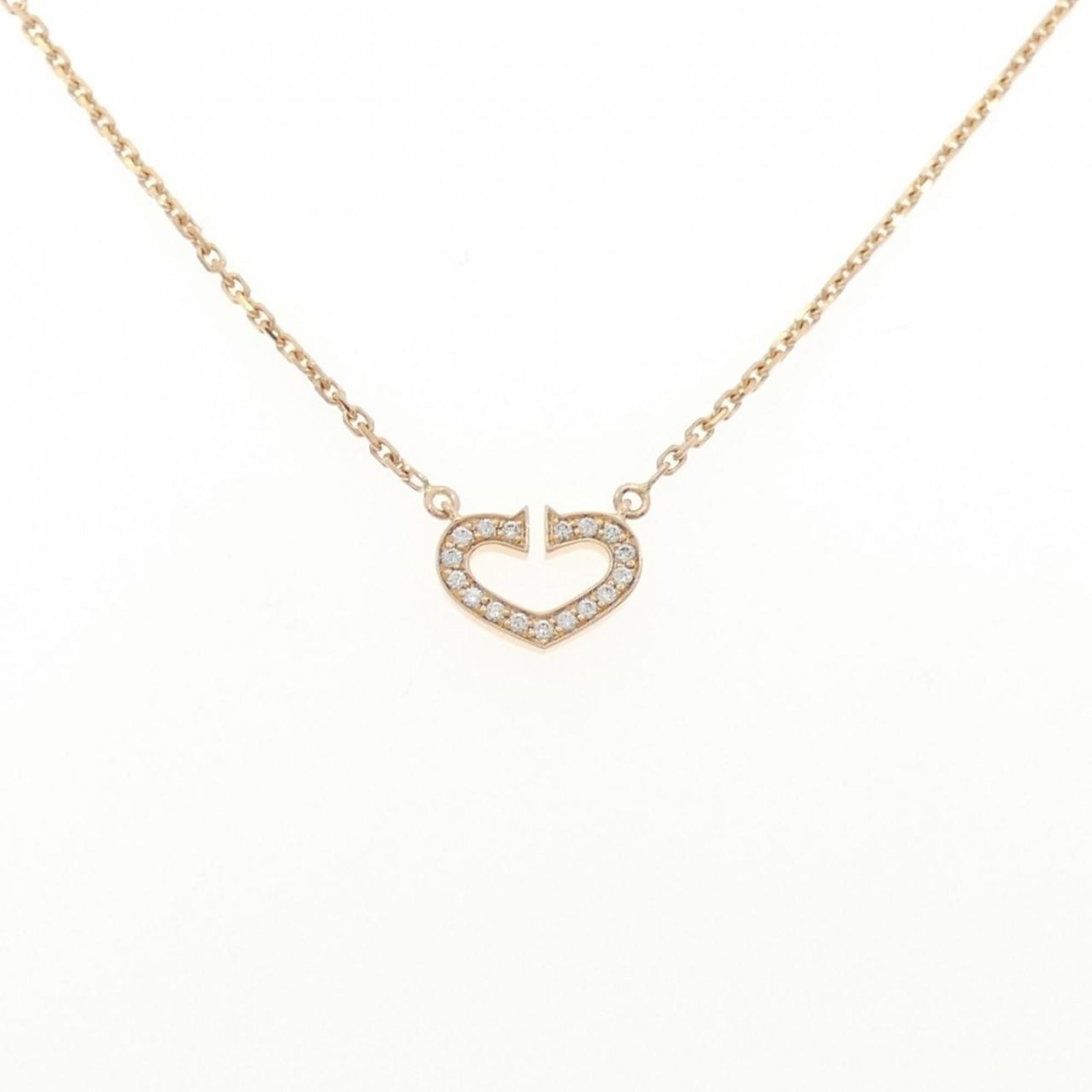 C Heart Necklace by Cartier: C Heart Necklace by Cartier 18K gold pendant featuring a pink diamond, weighing 5.3g, suspended from a necklace with a 39 cm circumference. The Cartier B7008200 model boasts elegant design and