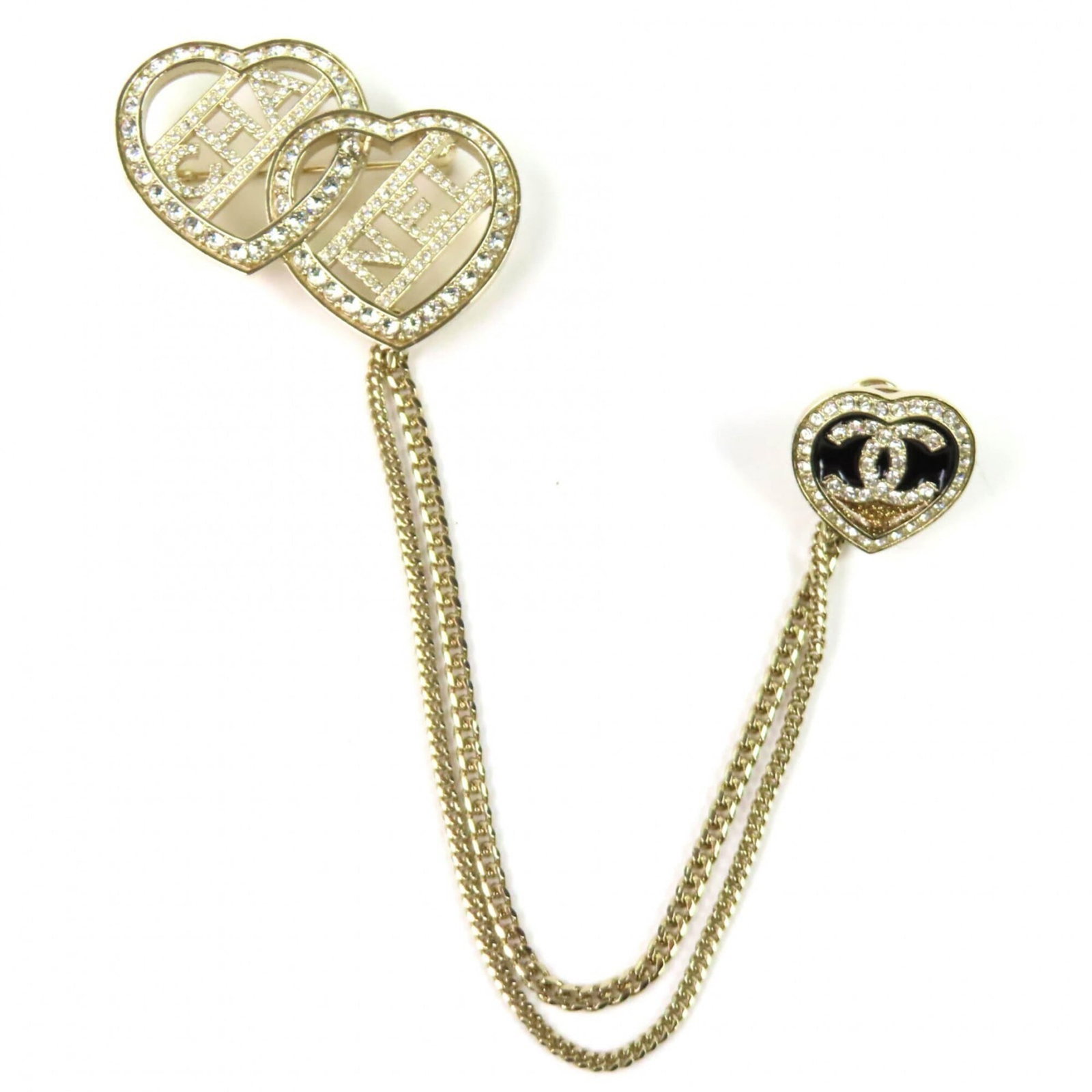 Metal Chanel Brooch: Metal Chanel Brooch Metal Chanel Brooch in Gold. This gold metal brooch measures 3.3cm x 4.3cm and features a charm size of 1.30'' x 1.69''. The brooch is made from metal and bears the iconic Chanel
