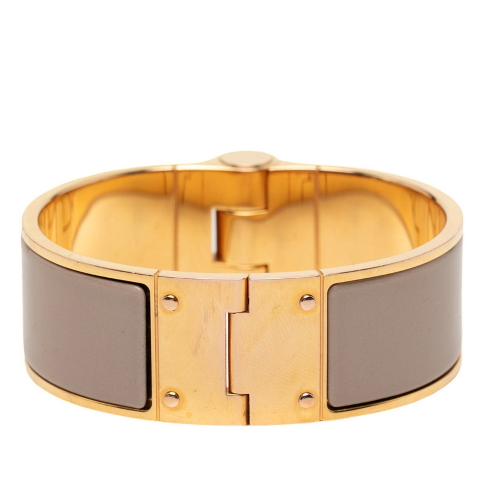 Hermes Bangle: Hermes Bangle The Hermes Bangle is a beautiful piece, featuring a beige color. This bangle bears a signature from the brand, showcasing its craftsmanship and attention to detail. Its classic design