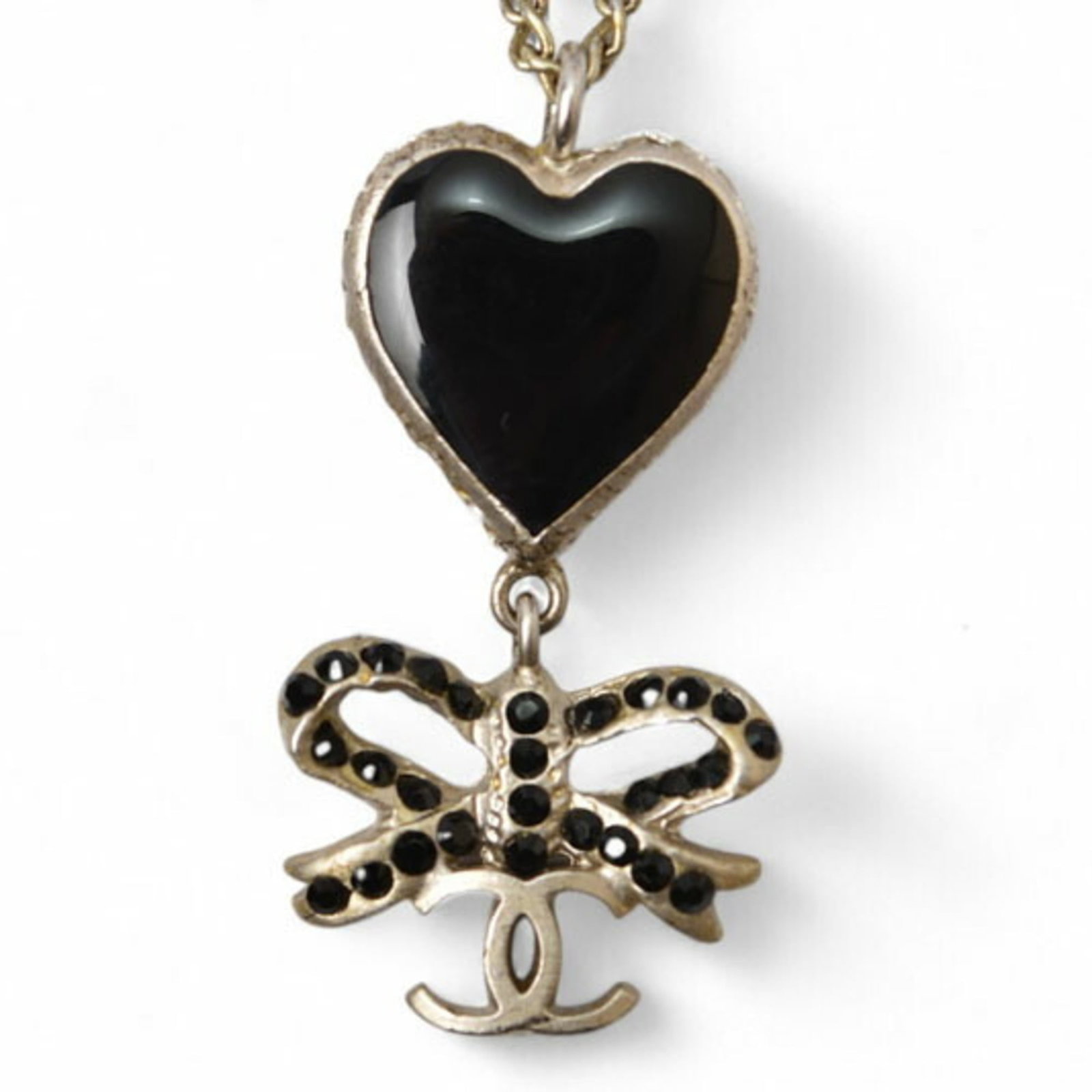 Chanel Black Silver Necklace Pendant Rhinestone Heart Coco Cc Ribbon Chanel: Chanel Black Silver Necklace Pendant Rhinestone Heart Coco Cc Ribbon Chanel Chanel's Black Silver Necklace Pendant Rhinestone Heart Coco Cc Ribbon is a striking piece featuring gold plating, black