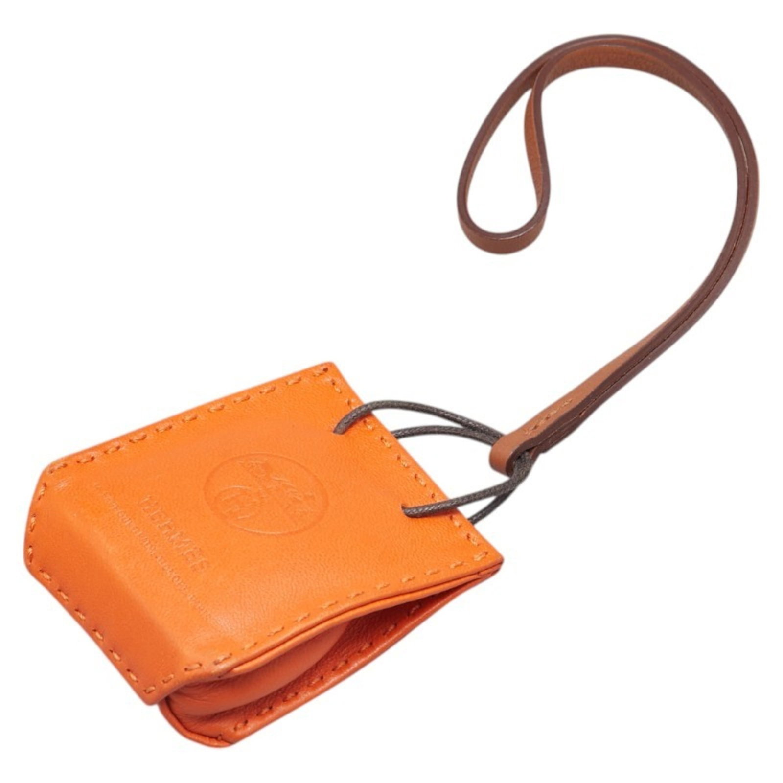 Hermes agneau handbag charm Milo: Hermes agneau handbag charm Milo Agneau Milo handbag charm from Hermes features a striking Feu, Orange color. Made from Agneau Milo material, this small charm measures 25.43mm x 17.82mm / 1.00'' x