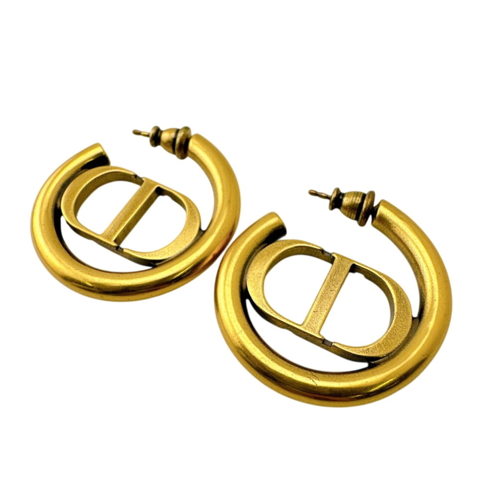 Metal Christian Dior Stud Earrings: Metal Christian Dior Stud Earrings Metal Christian Dior Stud Earrings are made from metal and feature the brand's signature. The gold color gives them a luxurious touch, while the stud design makes