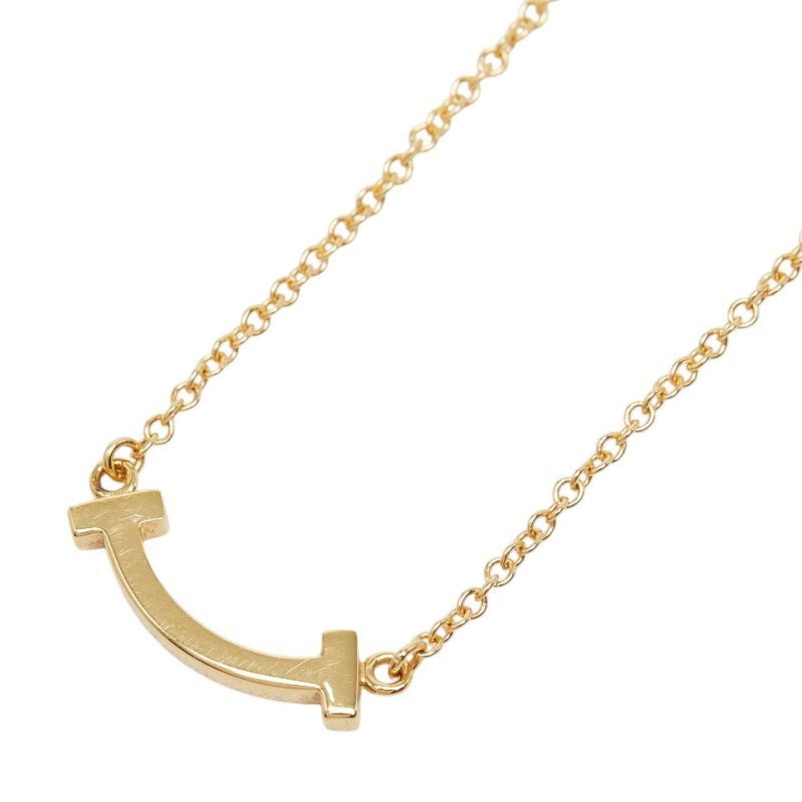 Tiffany & Co. T Smile Mini Chain Pendant Necklace 18K Yellow Gold (Au750) Women'S.: Tiffany & Co. T Smile Mini Chain Pendant Necklace 18K Yellow Gold (Au750) Women'S. 18K yellow gold pendant necklace from Tiffany & Co. features a T Smile mini chain pendant with a 5.1mm x 14.4mm size
