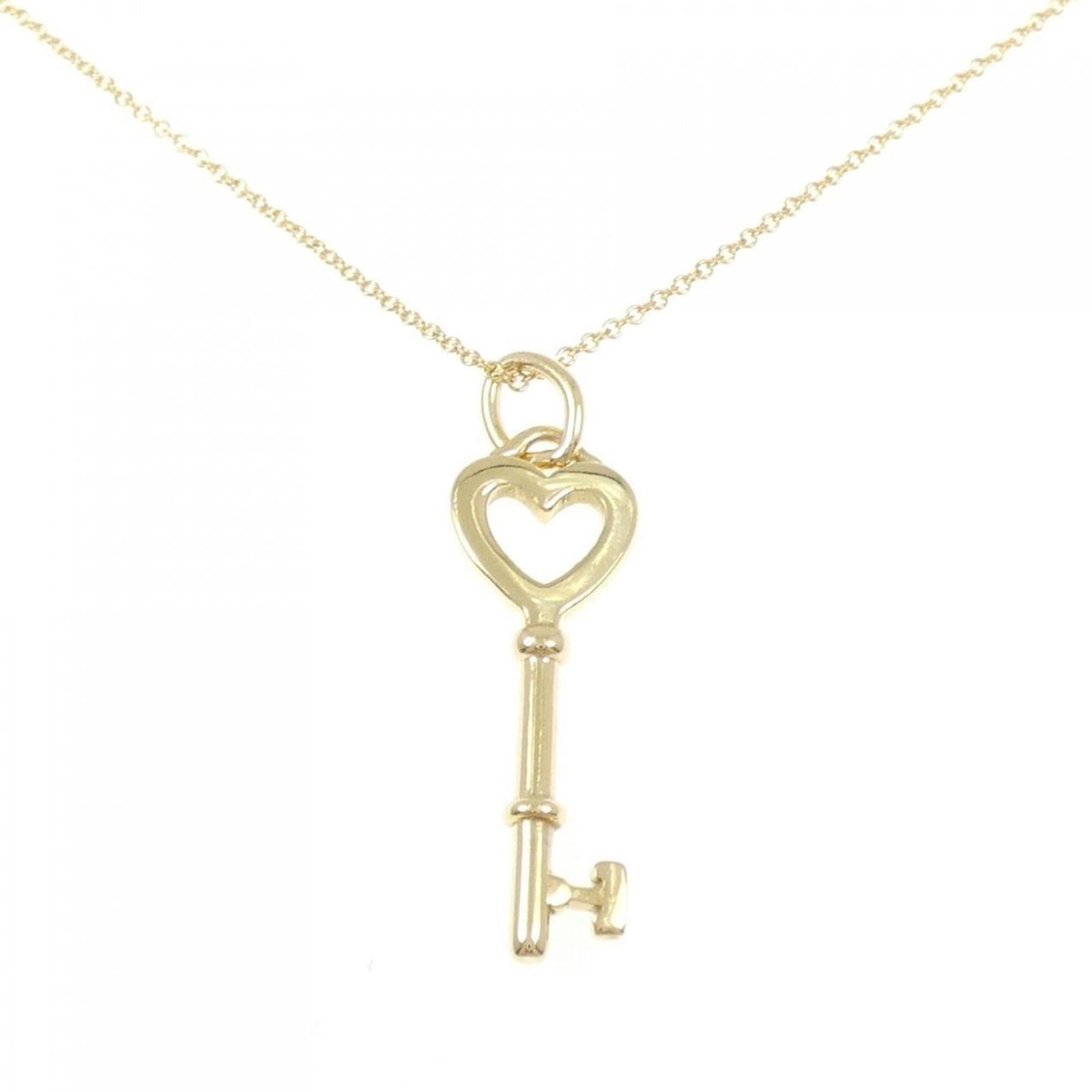 Mini key necklace by Tiffany: Mini key necklace by Tiffany Tiffany's iconic mini key necklace boasts a delicate 18K gold pendant, measuring 33.1mm x 9.6mm, suspended from a 41 cm chain. The yellow gold piece weighs 3.9g and bears 