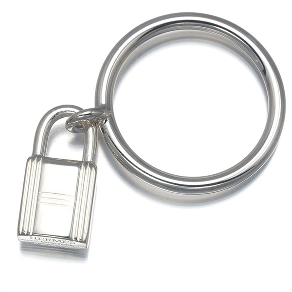 Sterling Silver Hermes Eu57 Ring Amulette Cadenas Kelly: Sterling Silver Hermes Eu57 Ring Amulette Cadenas Kelly Sterling Silver Hermes Eu57 Ring Amulette Cadenas Kelly features a sleek design with no stone, set on a base metal shank. The ring boasts a stur