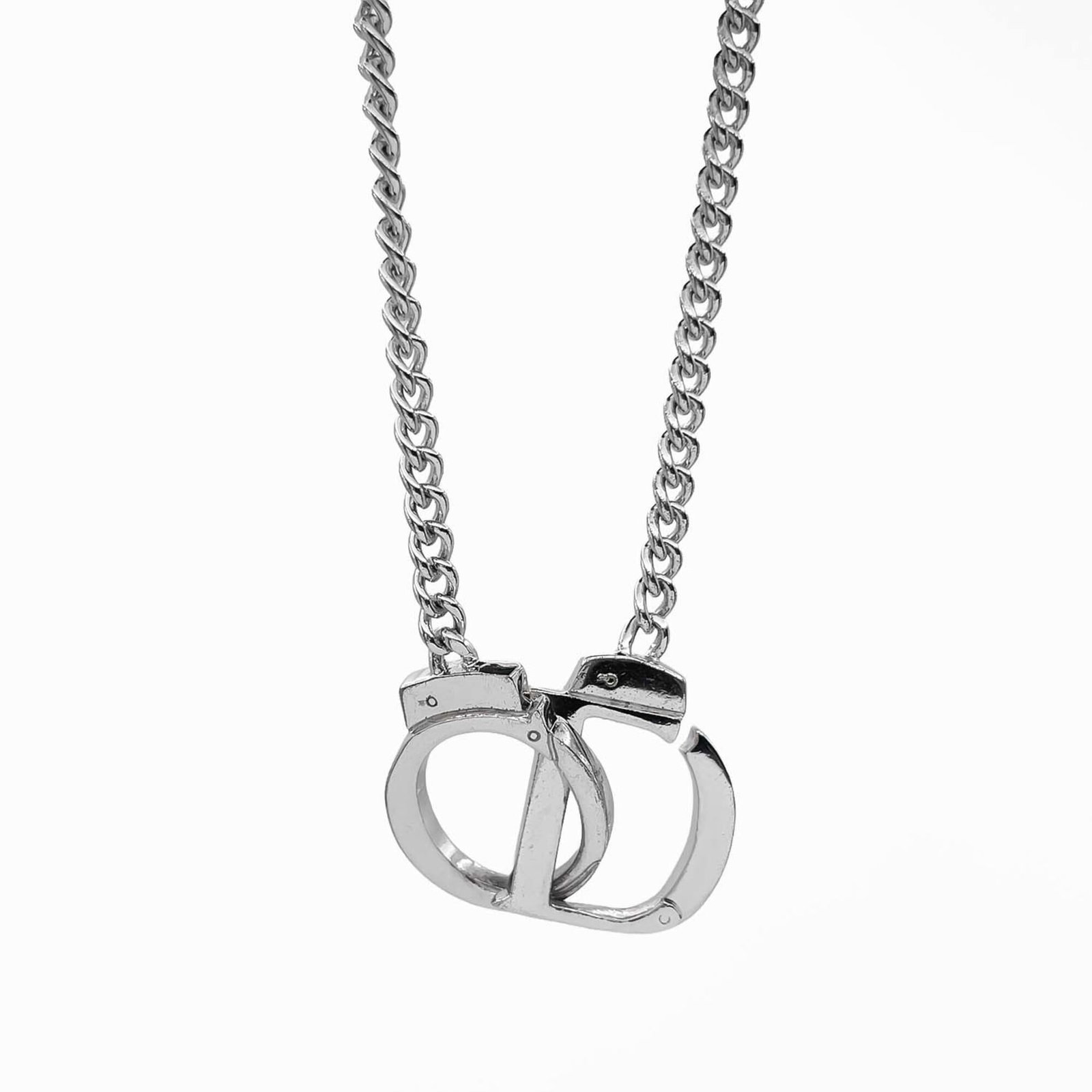 Christian Dior Handcuffs Cd Logo Necklace Pendant Metal Silver Women'S.: Christian Dior Handcuffs Cd Logo Necklace Pendant Metal Silver Women'S. Silver Christian Dior Handcuffs Cd Logo Necklace Pendant for Women. This silver necklace features the iconic Christian Dior
