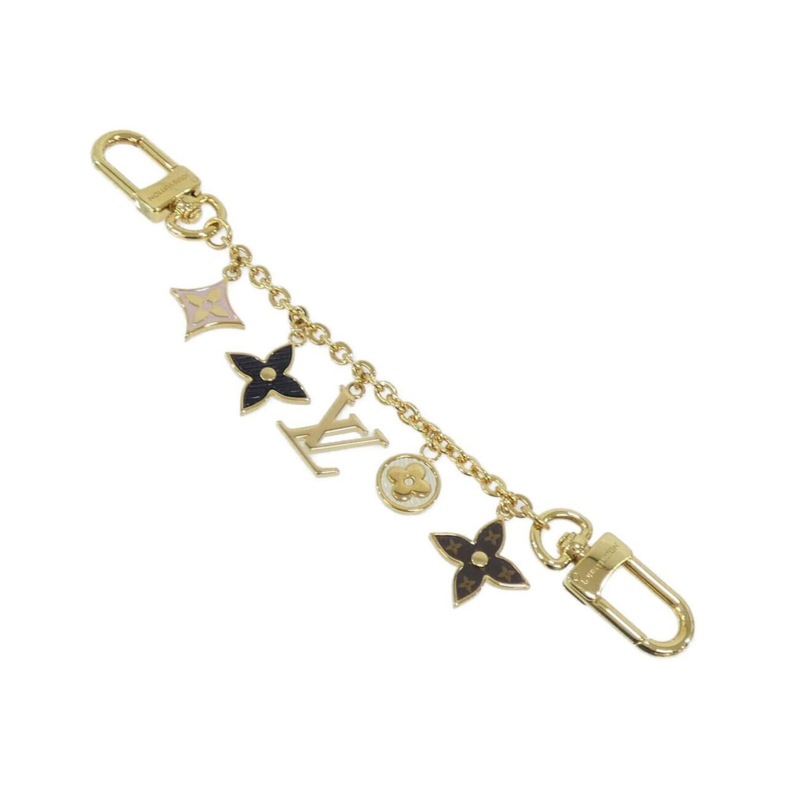 Louis Vuitton Handbag Charm: Louis Vuitton Handbag Charm Black, Gold, and Marron Louis Vuitton Handbag Charm. This charm features the iconic Louis Vuitton brand and design elements in three distinct colors. The M01188 MPN