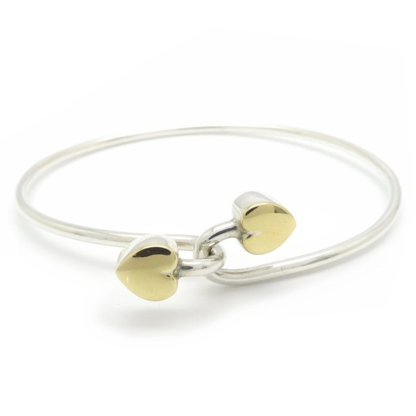 Tiffany Bangle Silver 925 Yellow Gold (18K): Tiffany Bangle Silver 925 Yellow Gold (18K) Tiffany's iconic bangle shines in sterling silver and 18K yellow gold, its sleek design measuring 17.5cm in length. This elegant piece boasts a premium