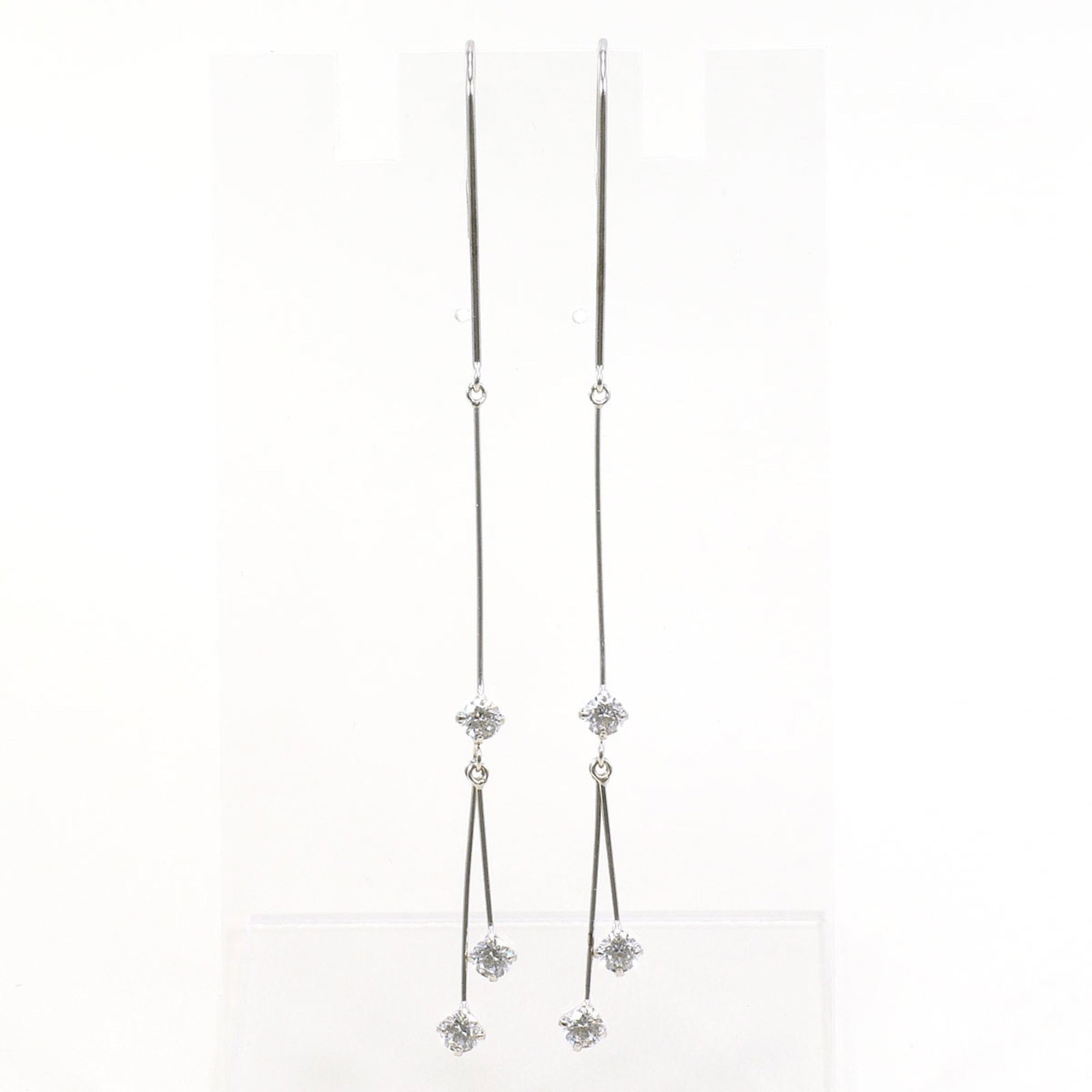 White Gold Unbranded 14K Drop Earrings: White Gold Unbranded 14K Drop Earrings White gold (14K) drop earrings with cubic zirconia stones, crafted from high-quality white gold metal. Weighing in at 1.3g / 0.04oz, these elegant earrings