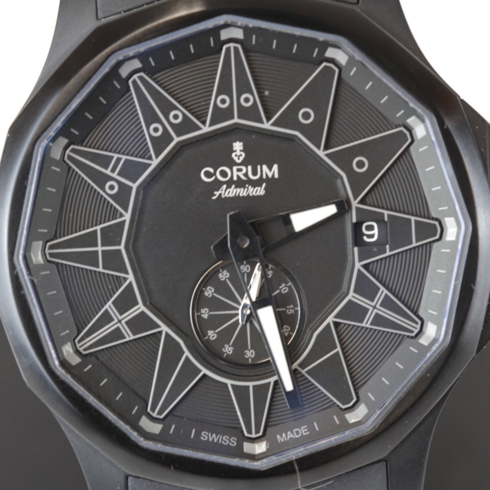 Corum Wristwatch: Corum Wristwatch Stainless steel case and band, the Corum Admiral's Cup wristwatch features a sleek black dial. Powered by a self-winding automatic movement, this timepiece boasts an analog display