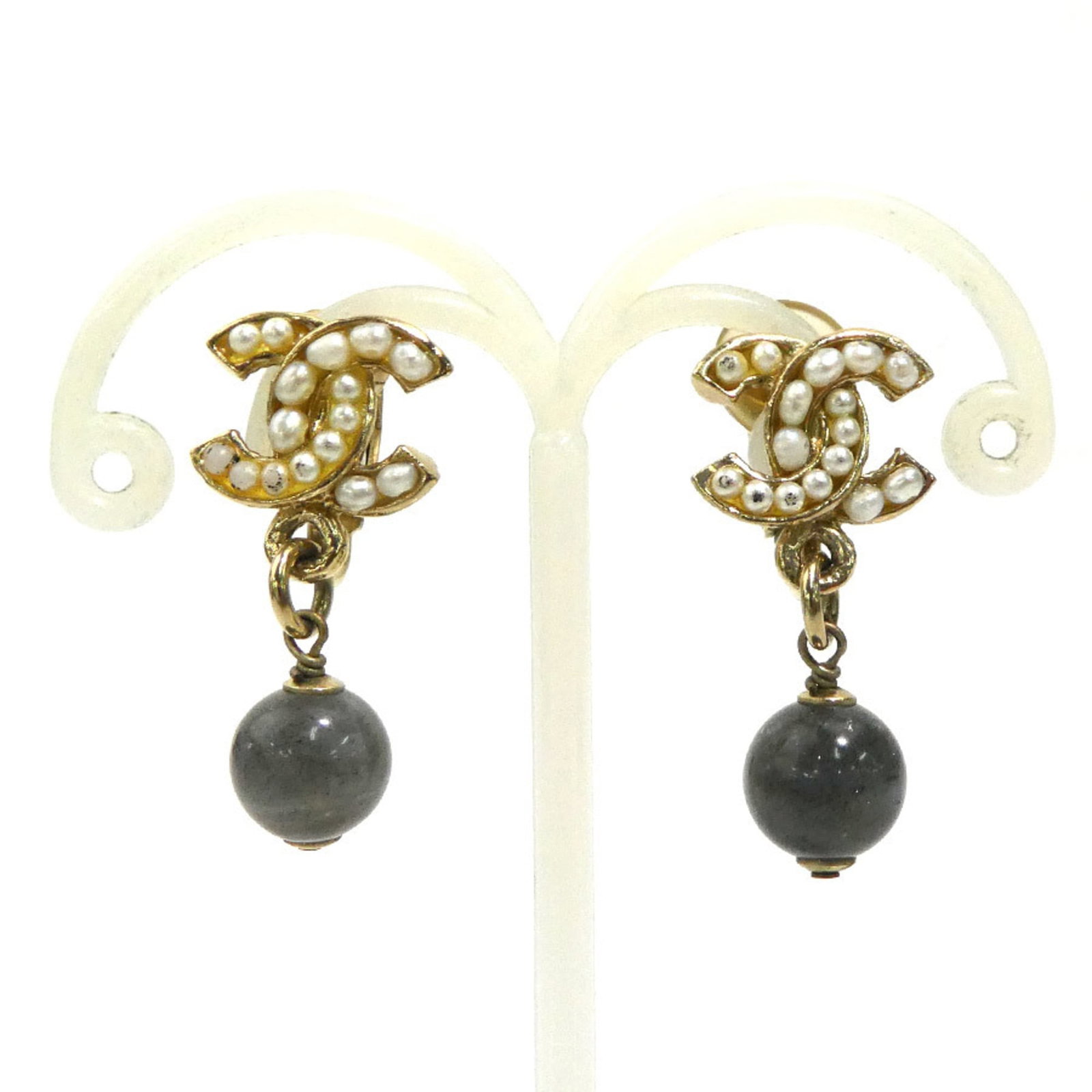 Metal clip earrings by Chanel: Metal clip earrings by Chanel Metal clip earrings by Chanel, crafted in gold, gray, and white metal, are a stylish accessory for women. The French brand's attention to detail shines through in these