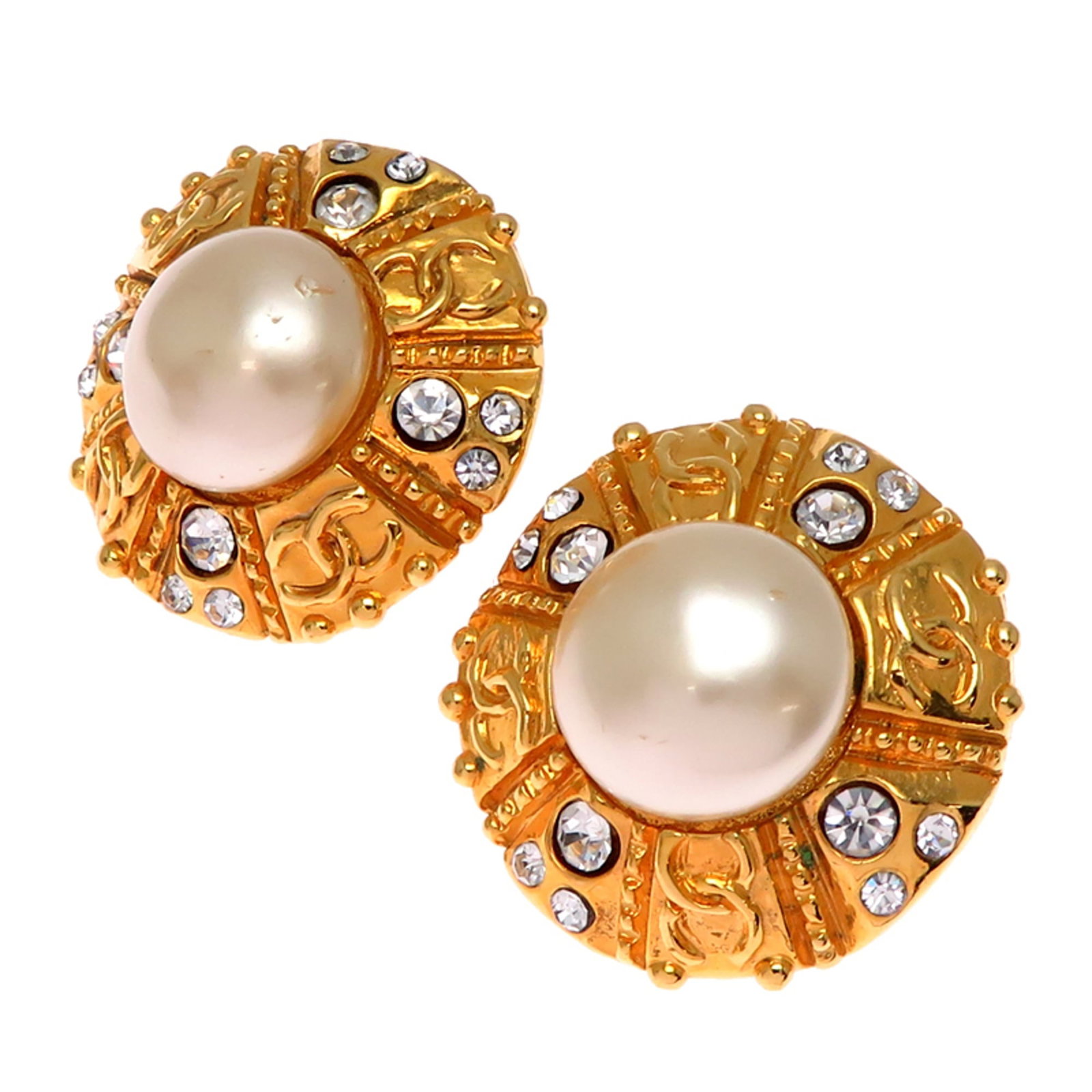 Clip earrings by Chanel: Clip earrings by Chanel Clip earrings by Chanel, featuring gold plated finish and adorned with pearl and rhinestone stones. The elegant design measures 29.20mm x 29.20mm in size. Comes in a box for