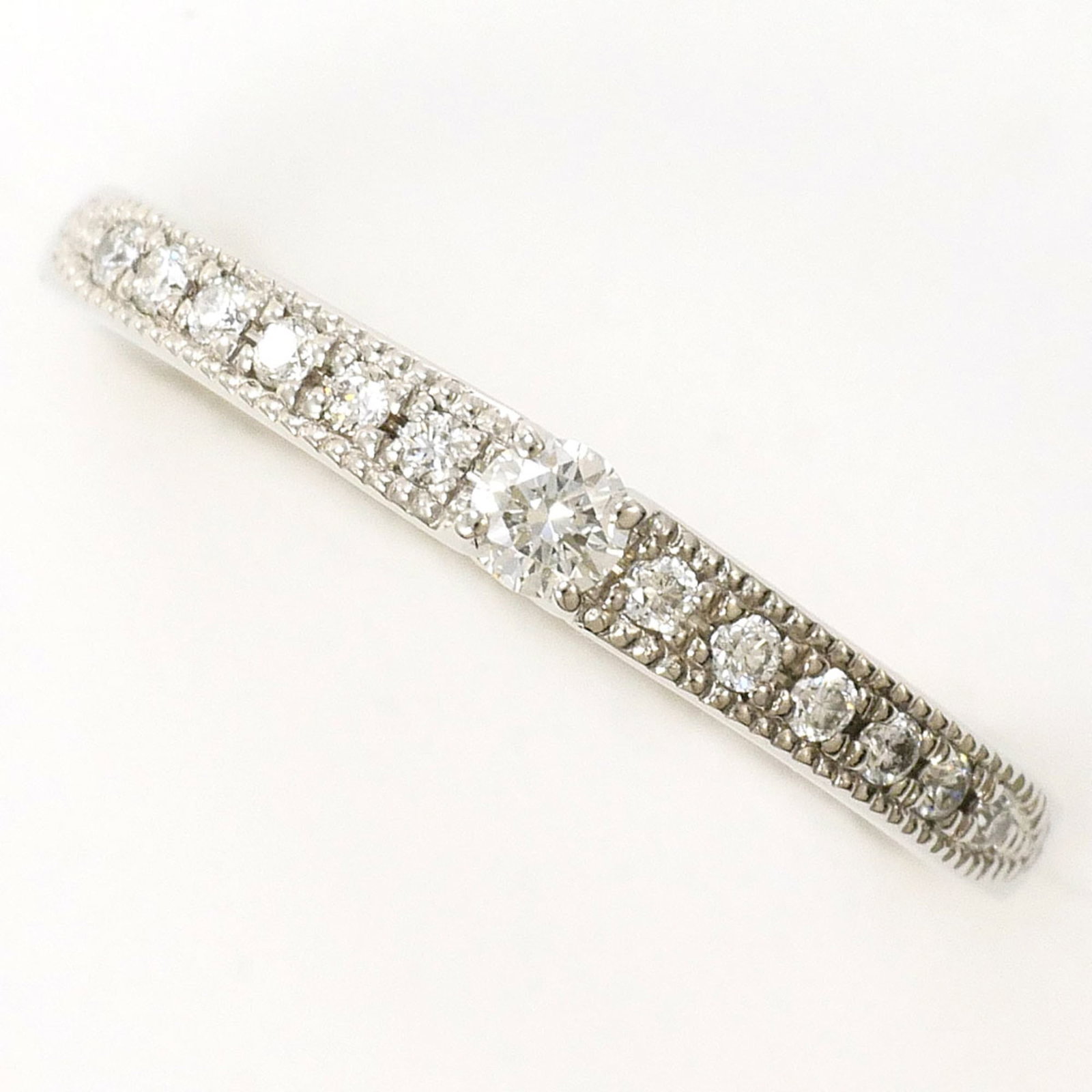 Ring Band Platinum Unbranded 900: Ring Band Platinum Unbranded 900 Platinum band ring with a diamond stone, weighing 0.121 carats, set in a platinum metal construction. This unbranded piece features a US size 3.5 and JP size 5 fit,