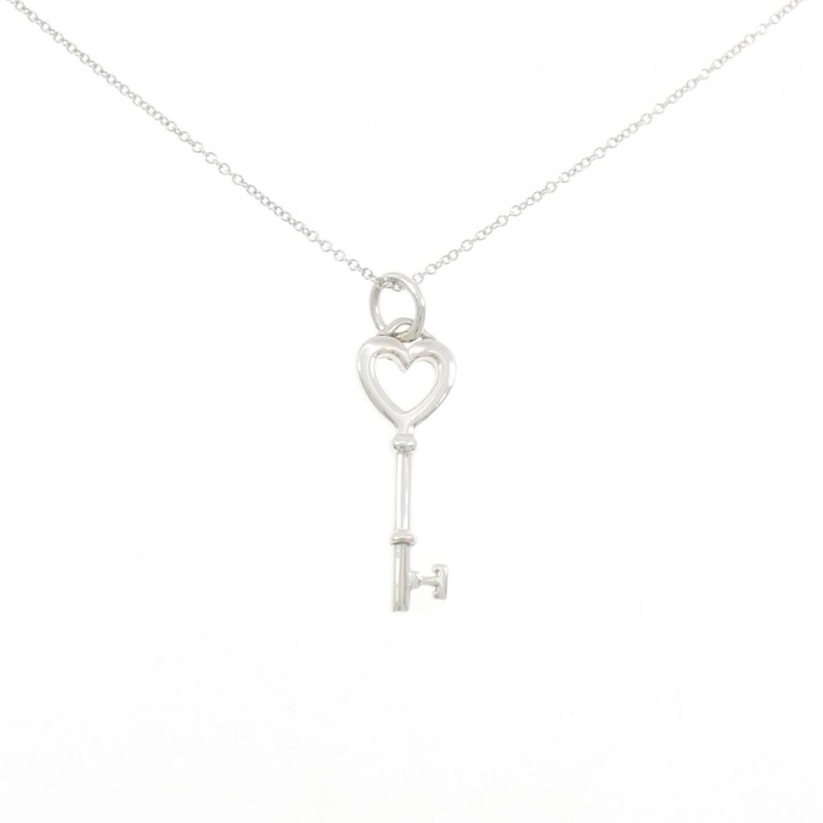 Mini key necklace by Tiffany: Mini key necklace by Tiffany Tiffany's mini key necklace boasts elegant simplicity with its sterling silver 925 material and sleek design, measuring 32.4mm x 9.5mm in size. This understated pendant fe