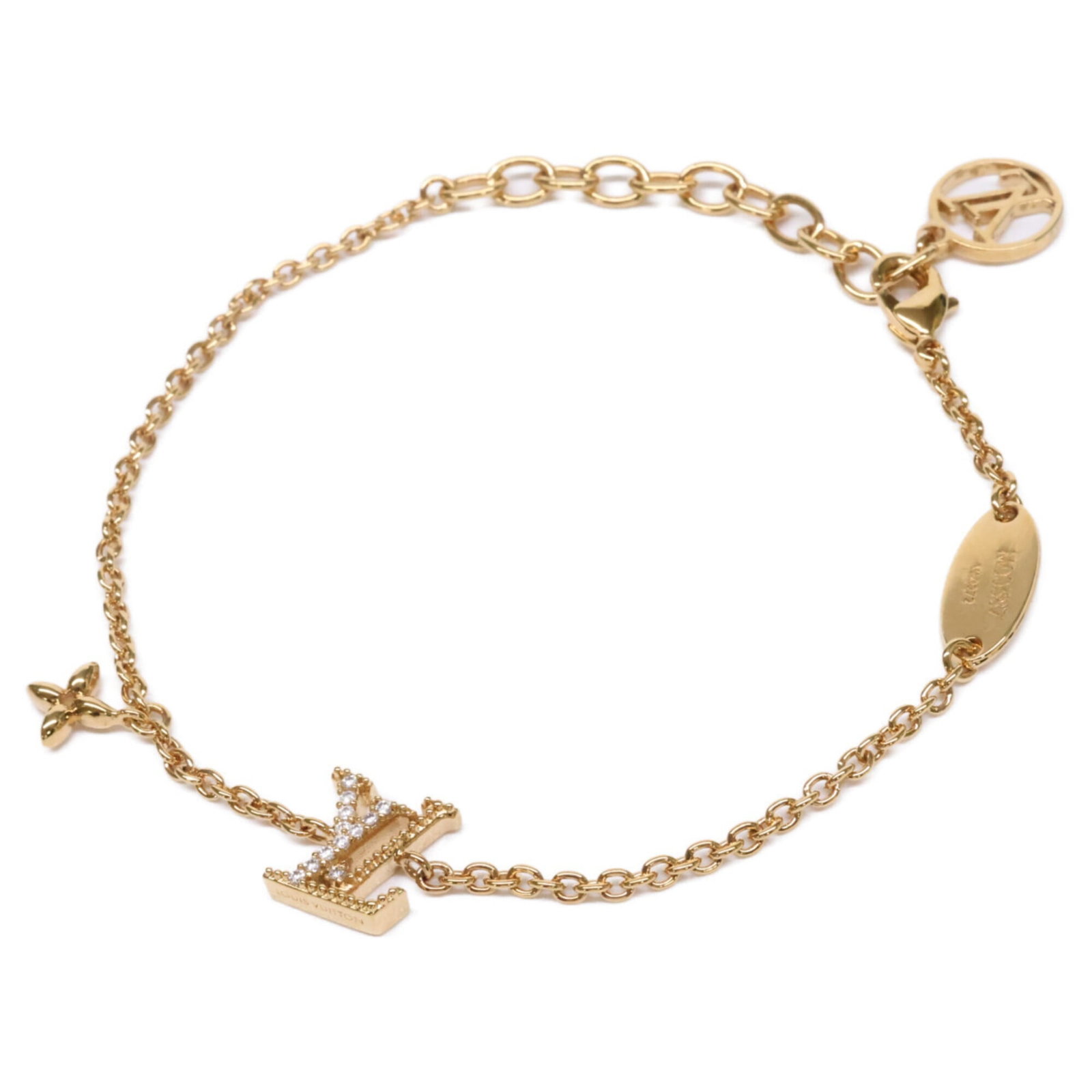 Metal Charm Louis Vuitton: Metal Charm Louis Vuitton Gold Louis Vuitton Metal Charm Bracelet, measuring 19cm in length. This charm bracelet features the iconic Louis Vuitton design, crafted from metal and available in gold colo