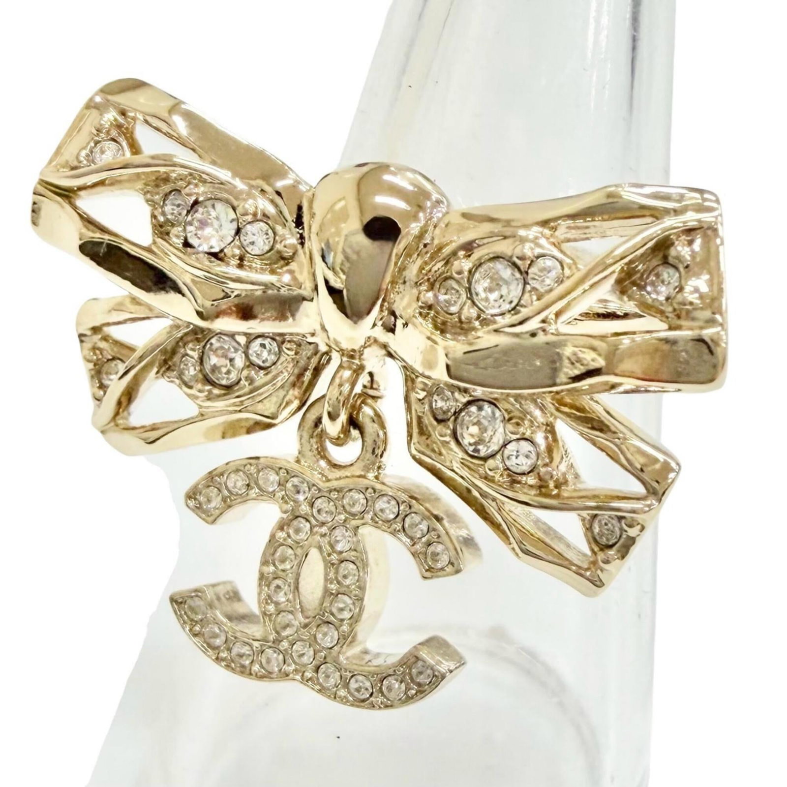 Ring Chanel Band: Ring Chanel Band Gold ring band from Chanel, featuring rhinestone stone and made in Italy. This women's band ring is available in US size 6 and JP size 11. The item bears a signature but authenticity