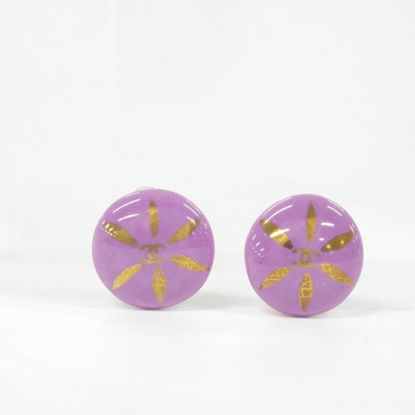 Clip earrings by Chanel: Clip earrings by Chanel Clip earrings by Chanel, featuring a gold and purple design, are available in a compact box. Measuring 23.00mm x 23.00mm, these clip earrings showcase the iconic style of the l