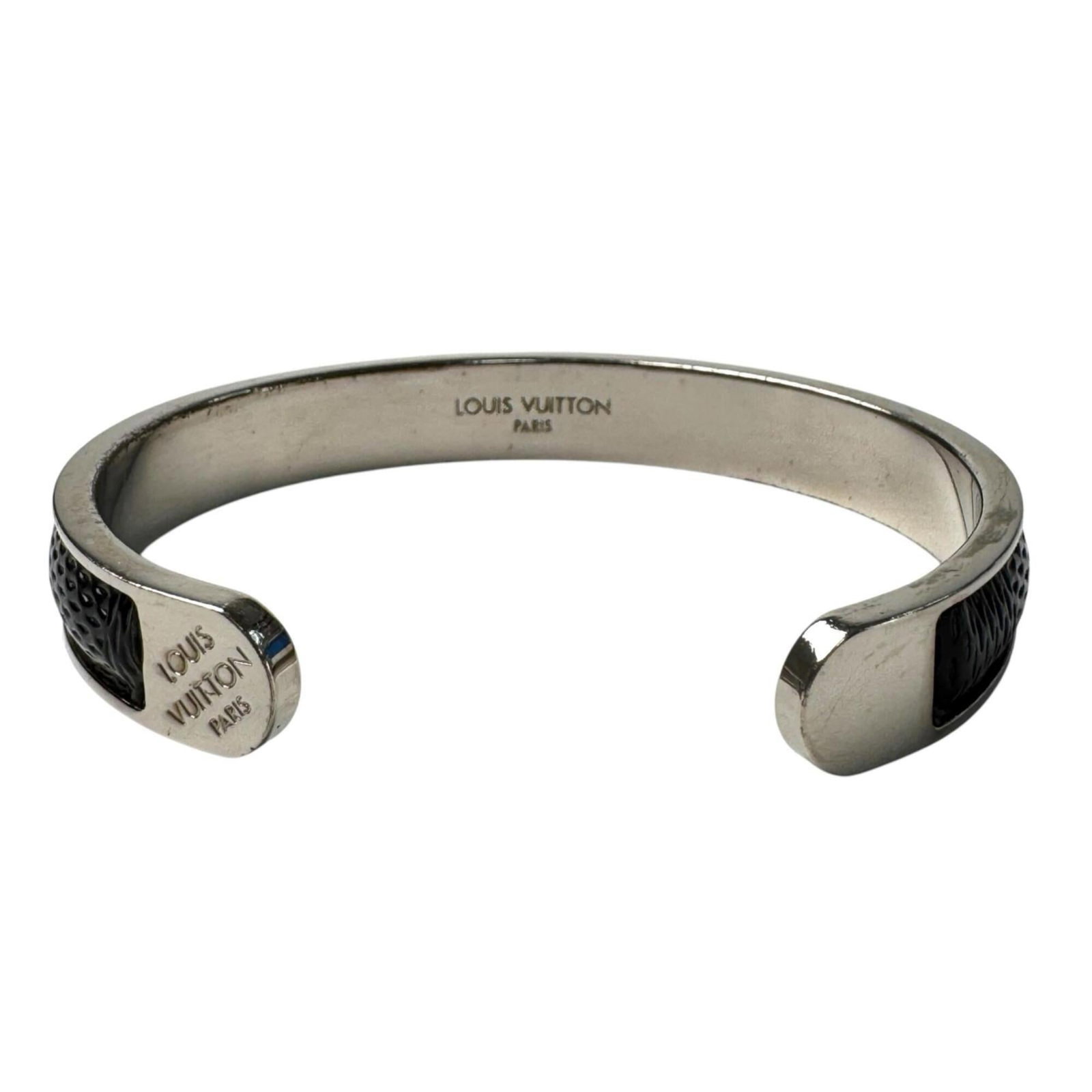 Metal Bangle by Louis Vuitton: Metal Bangle by Louis Vuitton Metal Bangle by Louis Vuitton, featuring a sleek black and silver design, measures 18.5cm in length. This bangle showcases the iconic style of the luxury brand, with its